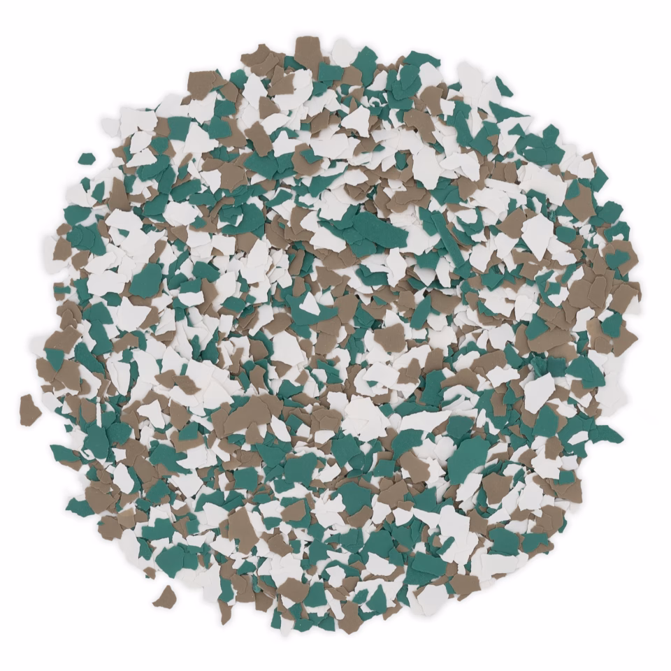 Pile of small, irregular green, white, and brown flakes scattered on a white background.