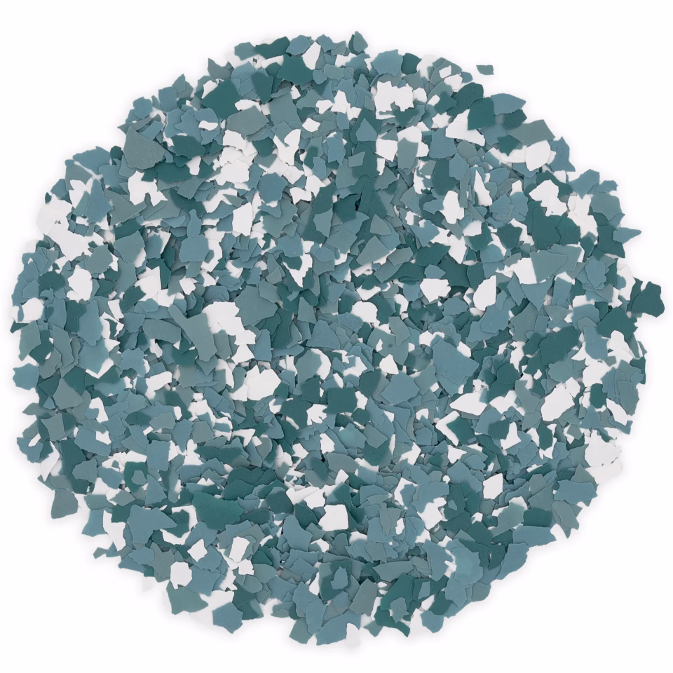 Pile of blue and teal irregularly shaped chips or flakes scattered on a white background.