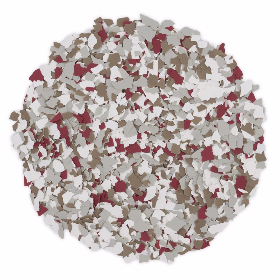 Pile of small paint chips in white, taupe, and burgundy colors scattered in a circular shape on a white background.