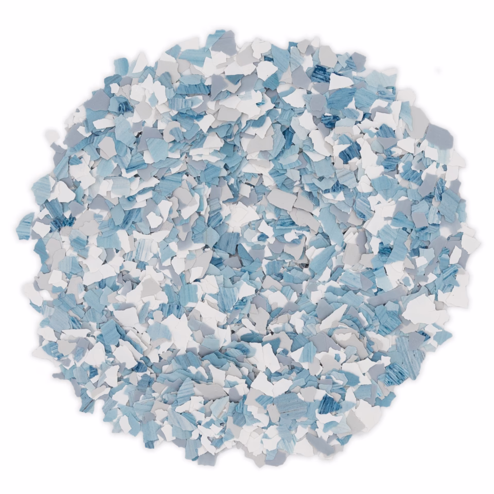 Pile of small irregular flakes in varying shades of blue and white on a white background.