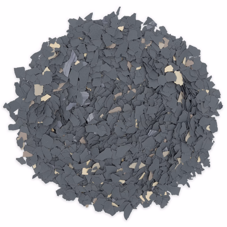 Pile of irregular dark grey and beige flakes scattered in a circular shape on a white background.