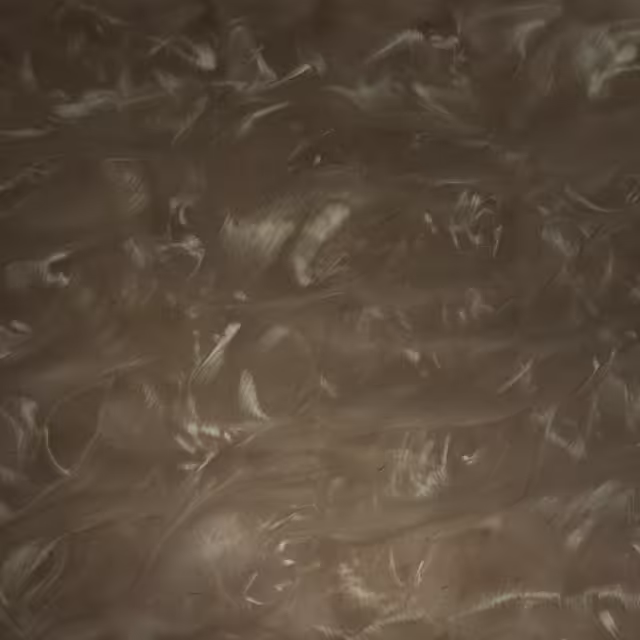 Pile of small, irregularly shaped gray and white stone flakes with a textured, layered appearance.