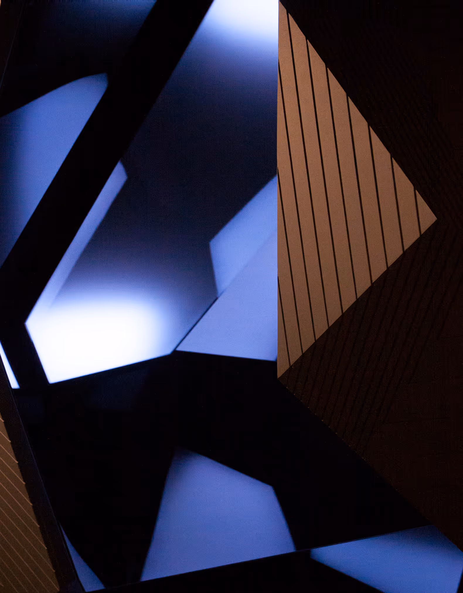 Abstract geometric shapes with blue light and brown wood panel with vertical lines.