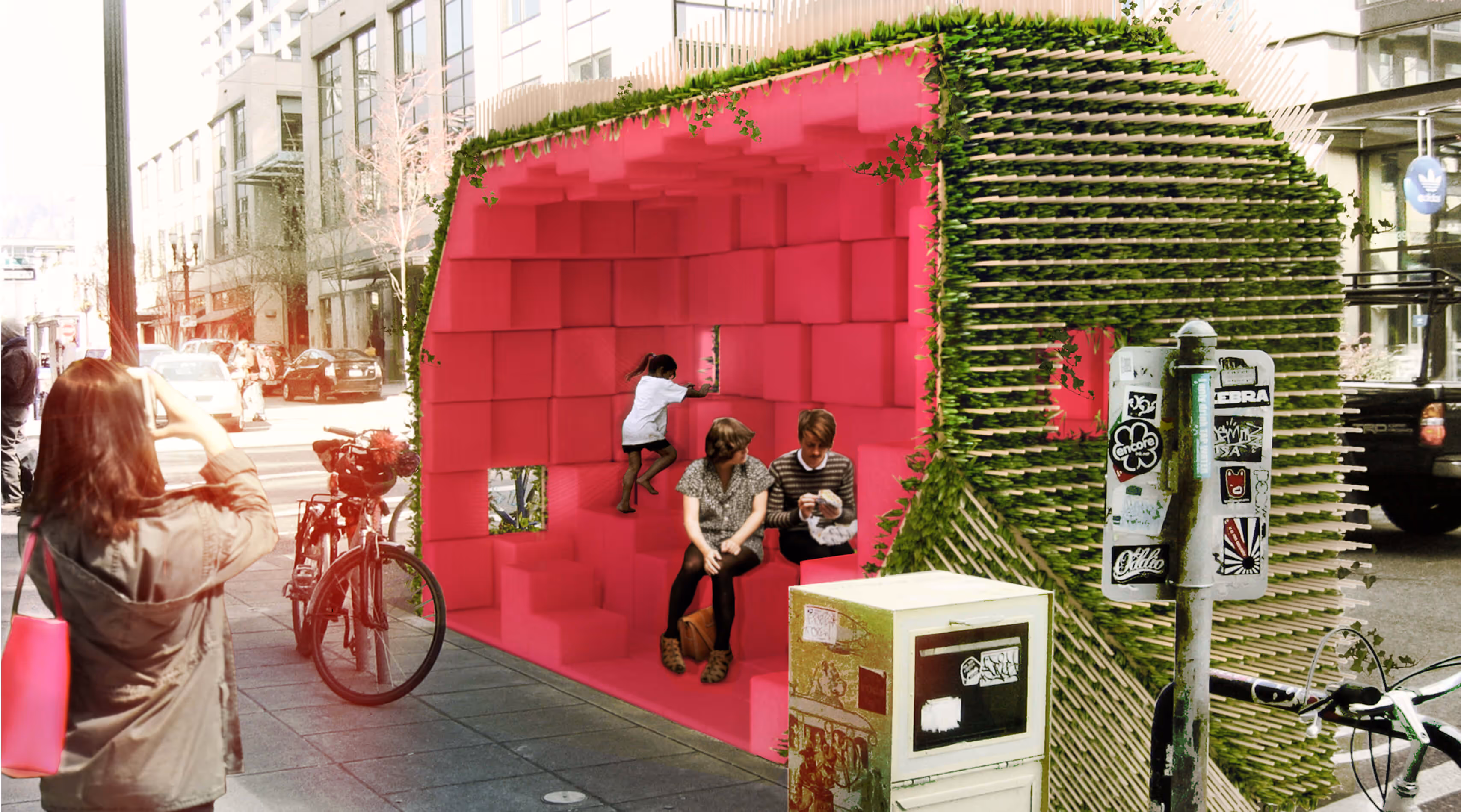 Pink cube-shaped seating installation with green edges on a city sidewalk with people and bicycles nearby.