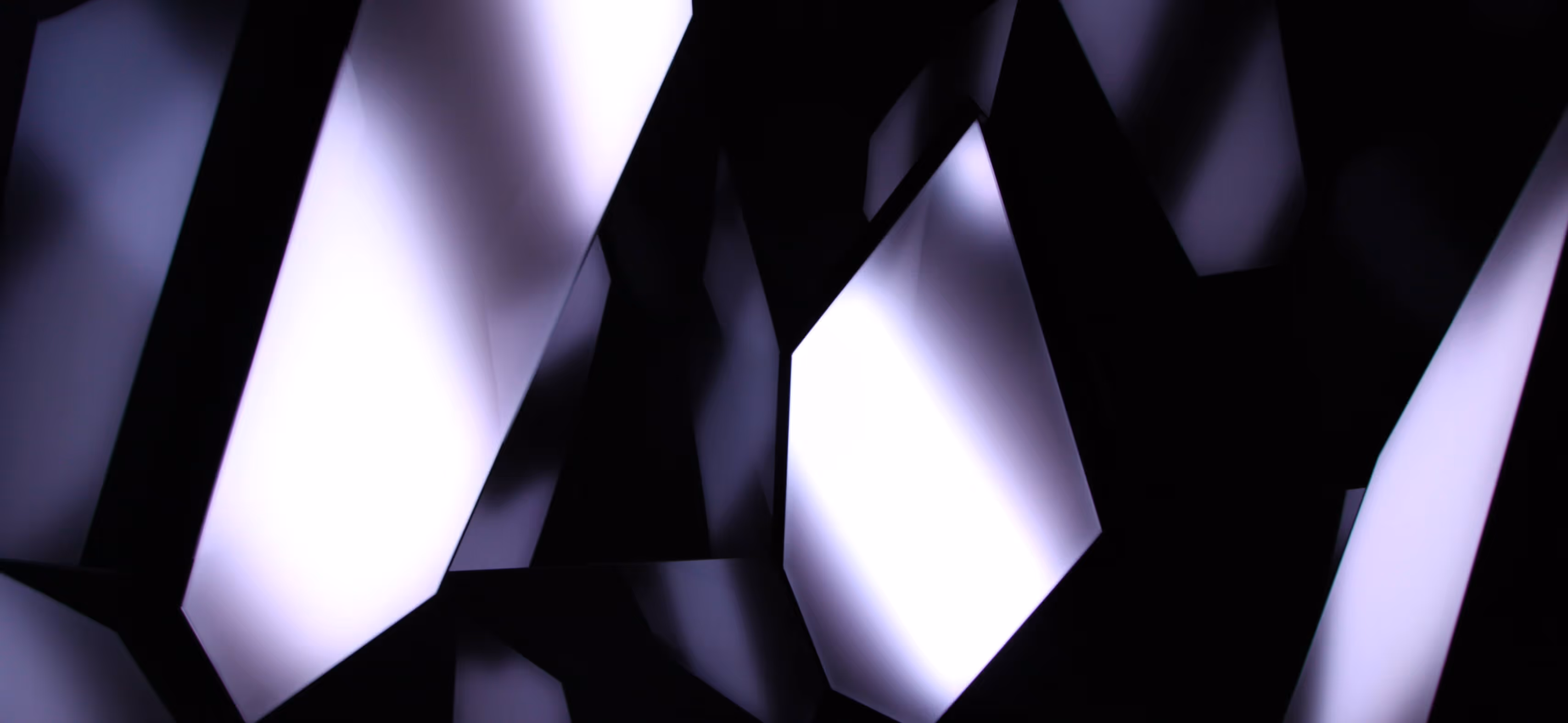 Abstract geometric shapes with illuminated white and purple surfaces against a dark background.