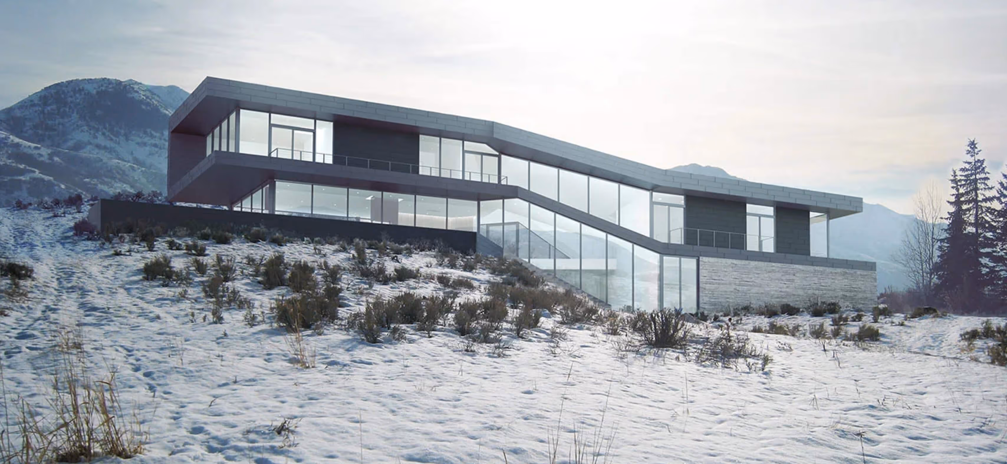 Modern house with large glass windows on snowy hillside with mountains in background.