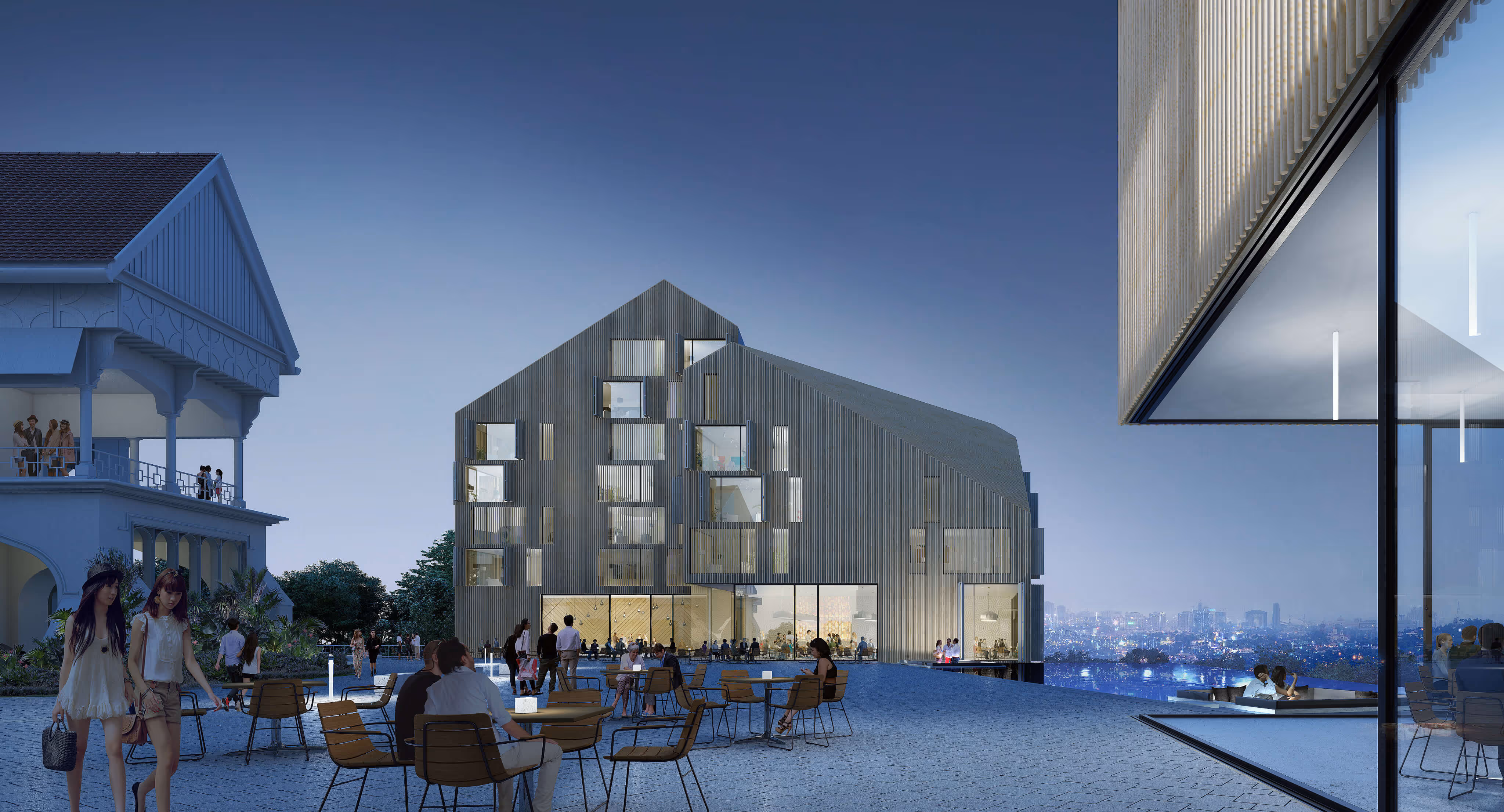 Modern angular building with large windows beside older colonial-style building at twilight with people sitting outside.