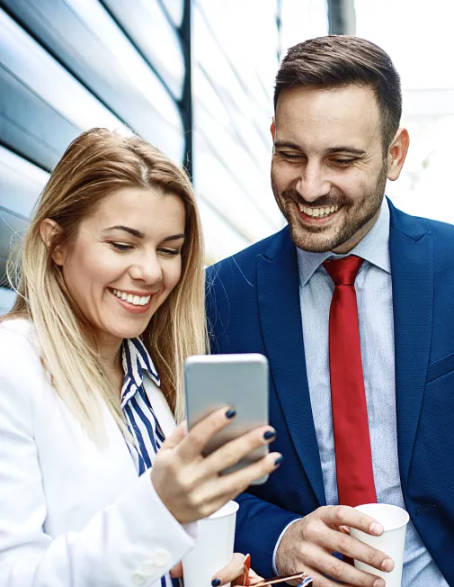 Woman and man looking at a mobile phone at work