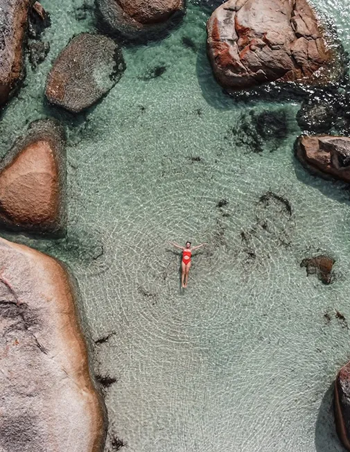Woman swimming at a beautiful beach