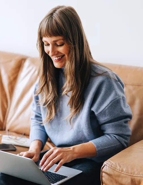 Woman typing on a laptop