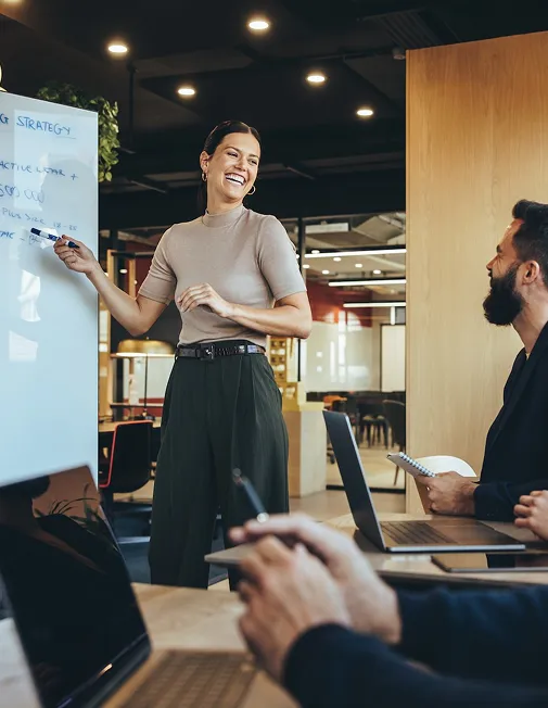 Woman presenting at a whiteboard