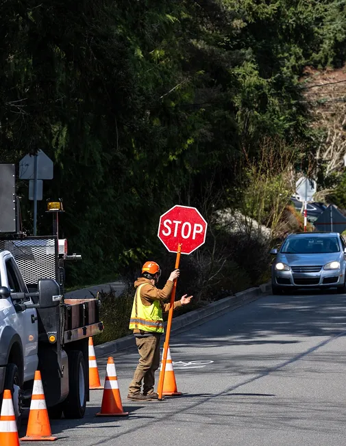 Man with stop sign in a traffic management area