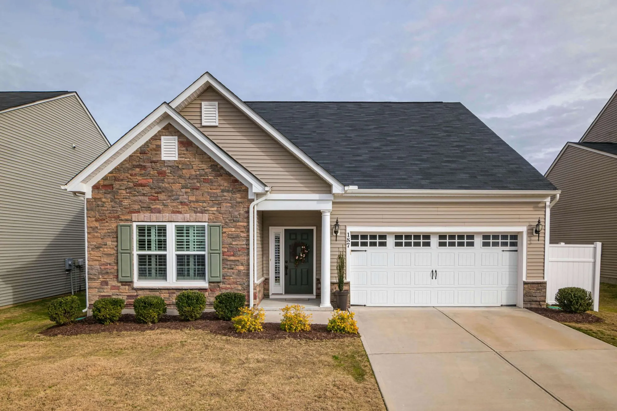 Single-family home with brick accents and a two-car garage