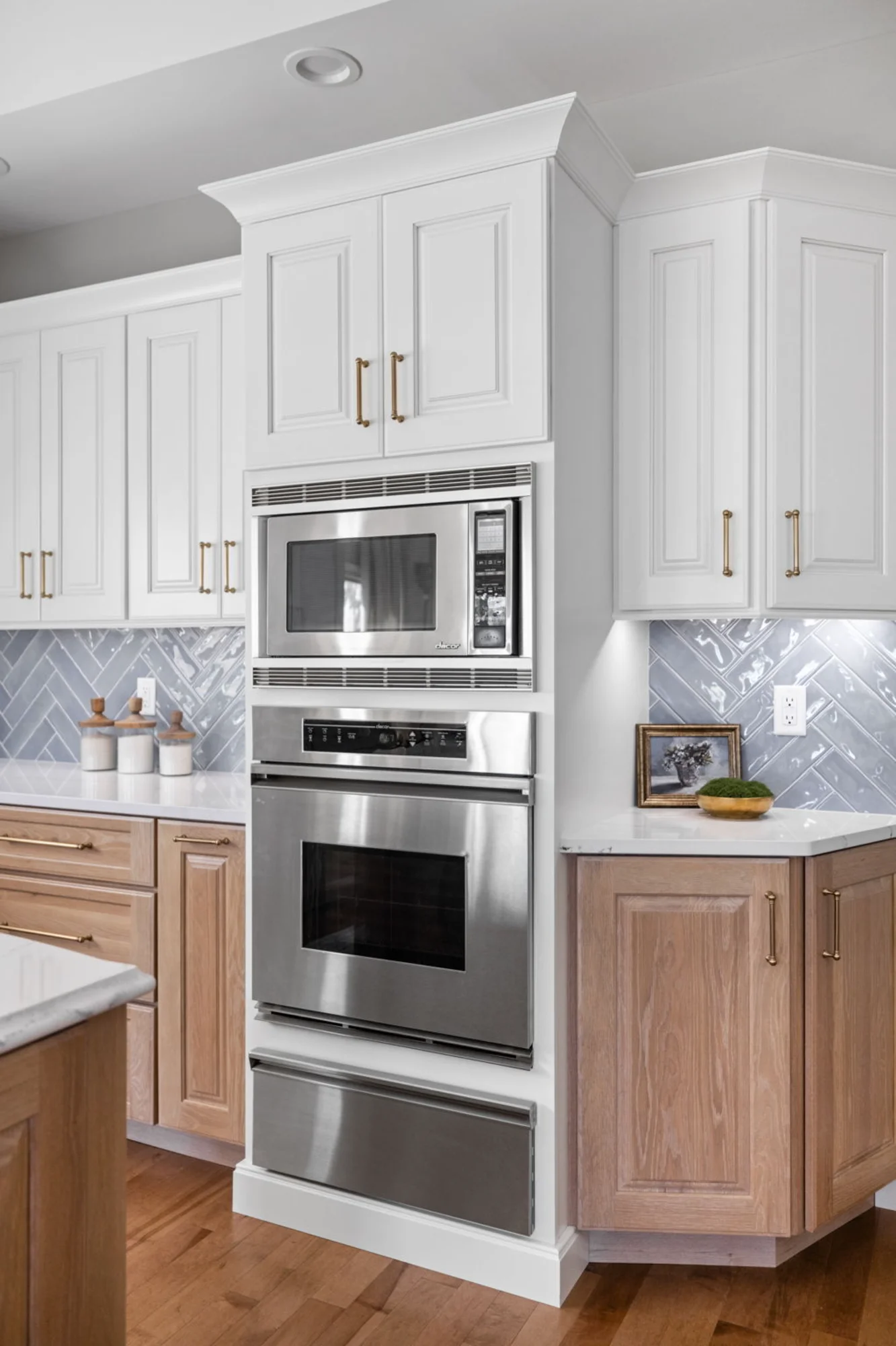 White kitchen corner with built-in oven and microwave