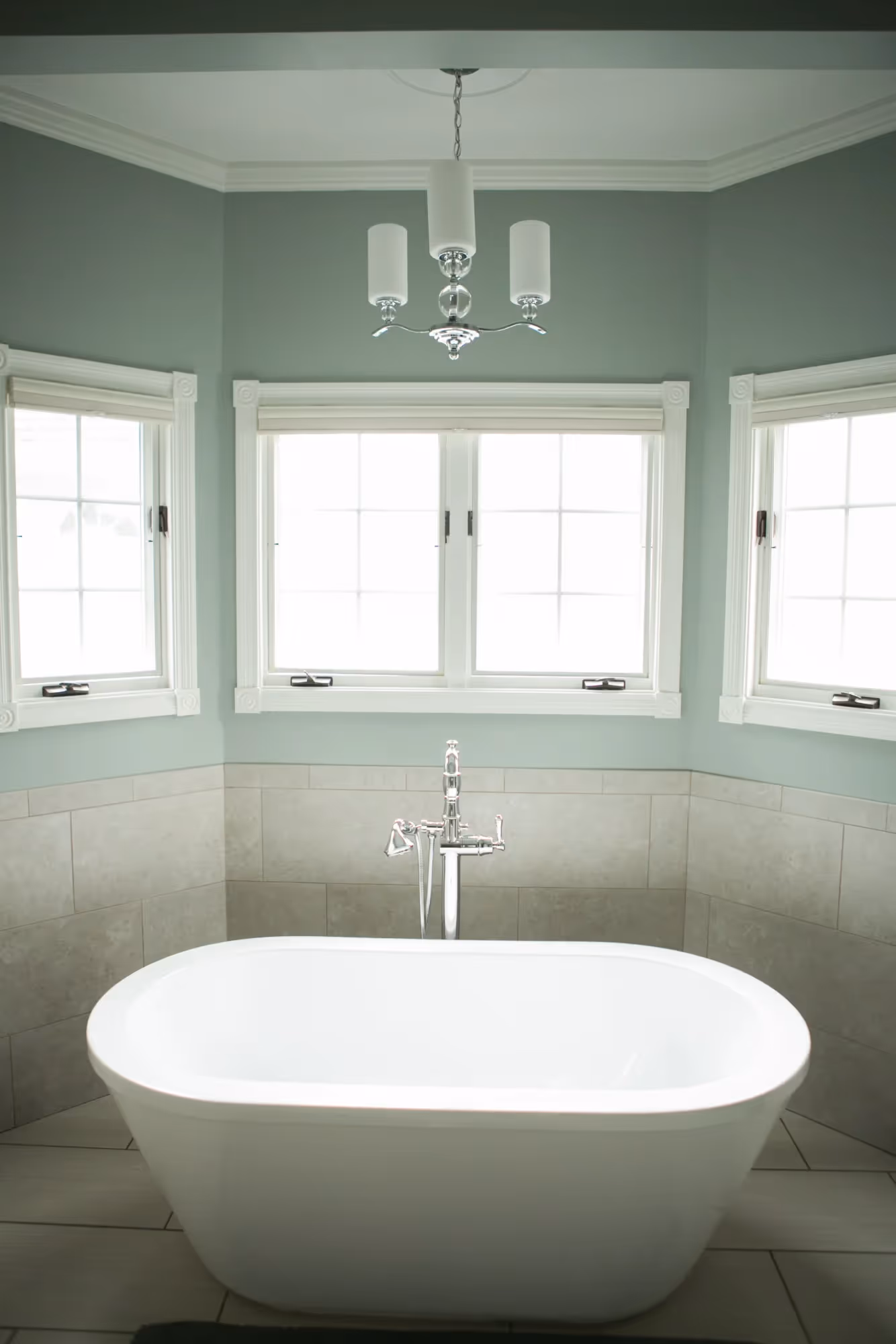 Freestanding bathtub in a bright bathroom.