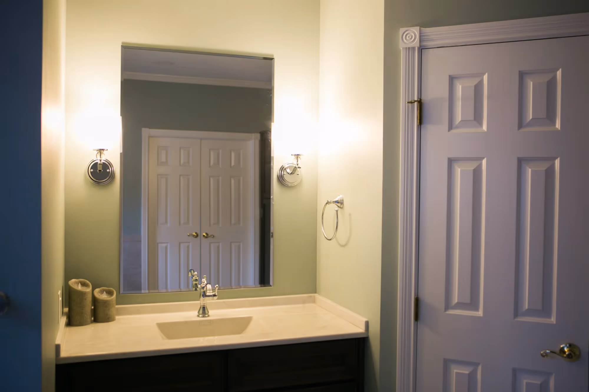 Bathroom sink with mirror and wall light.