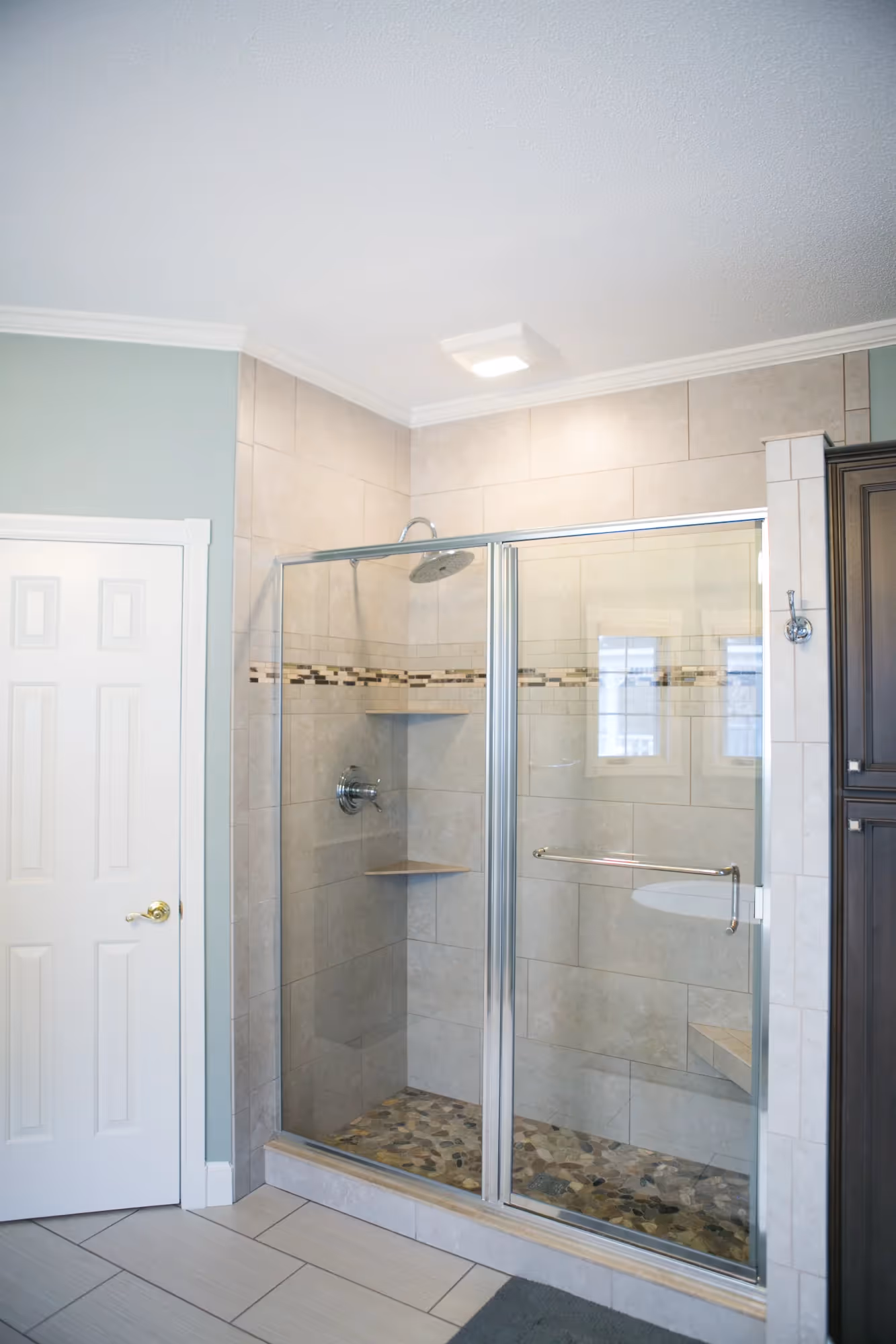Small bathroom with bright vanity and large wall mirror.