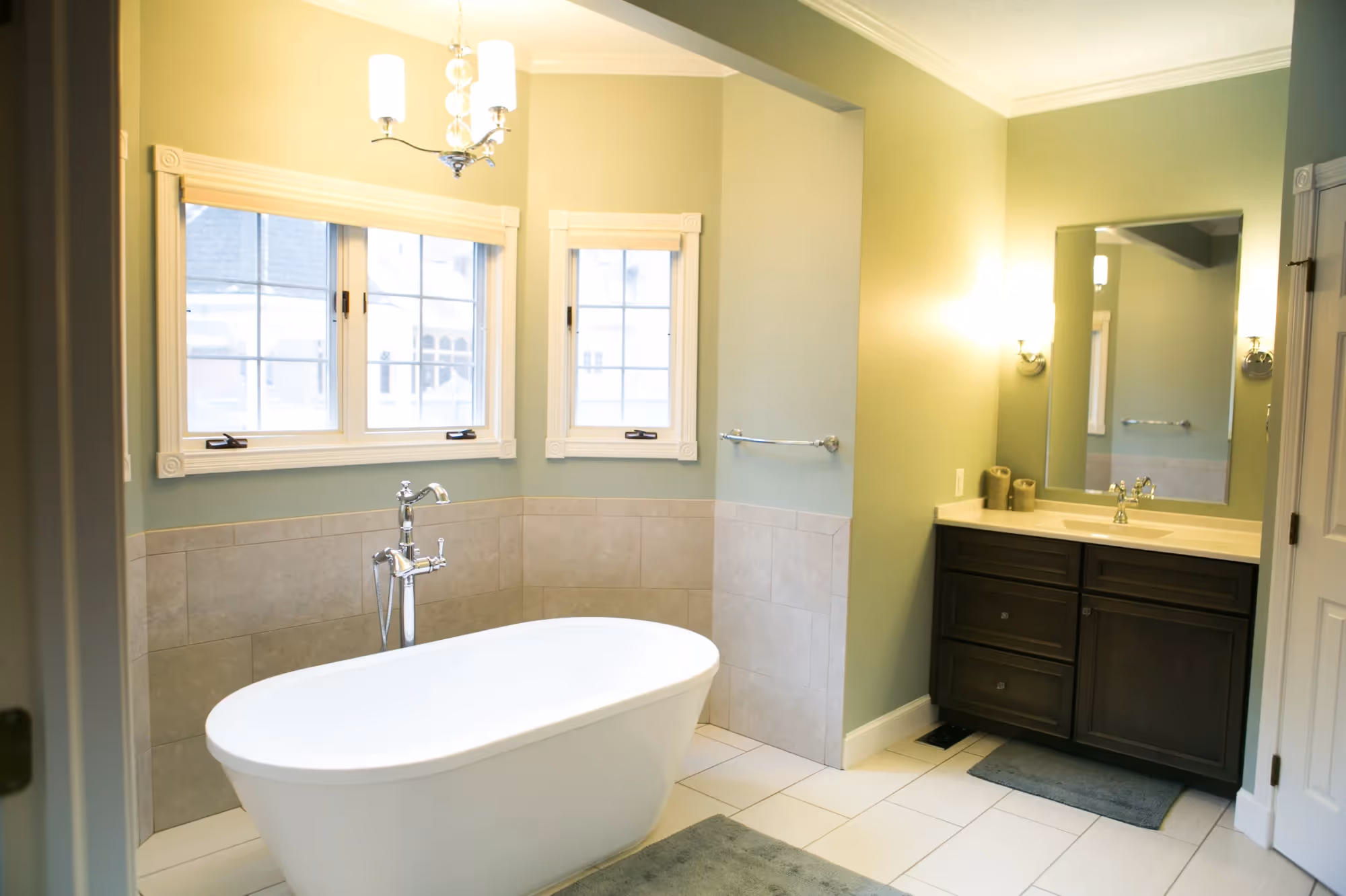 Modern bathroom with freestanding bathtub and double vanity.