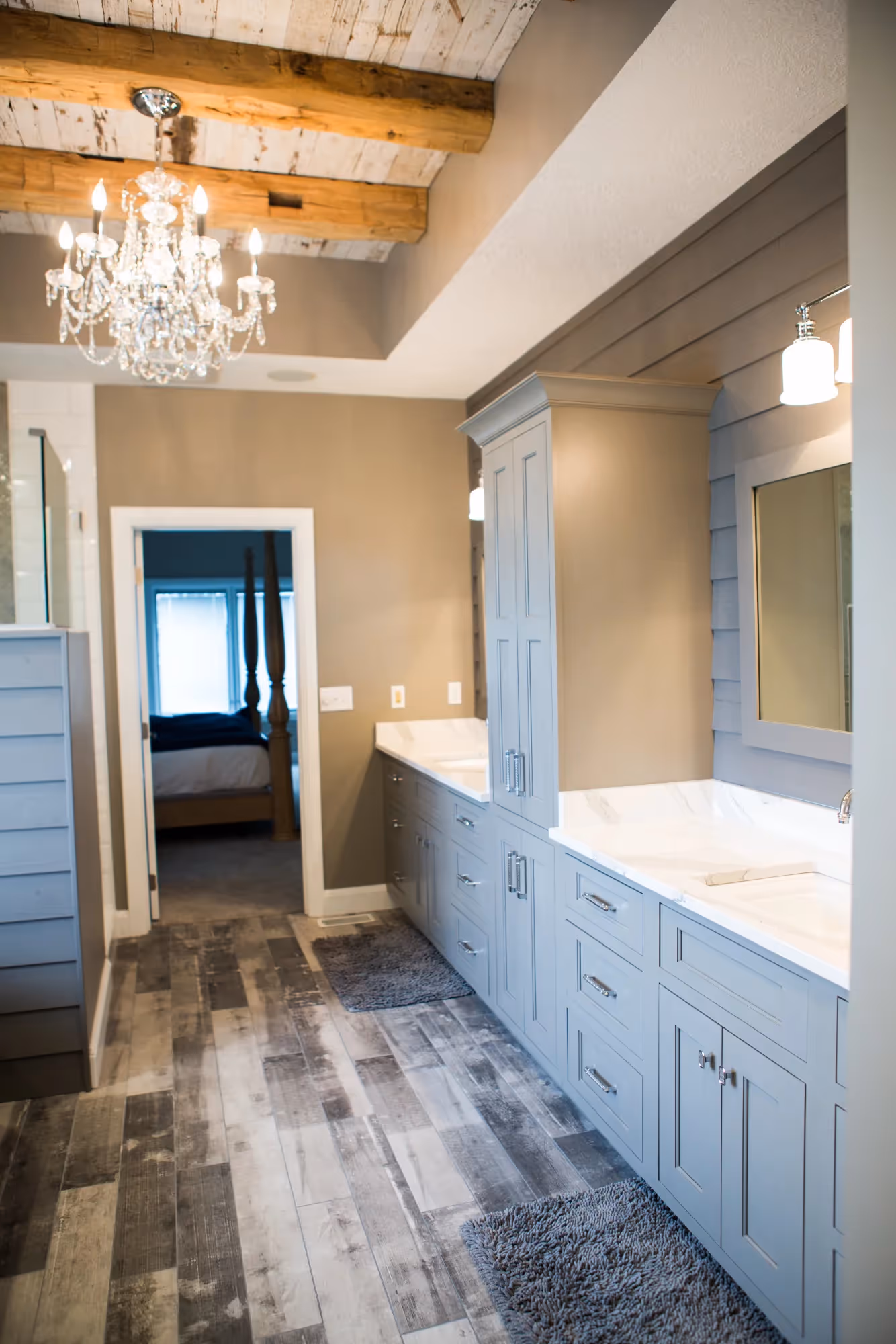 Long bathroom with double vanity and tiled shower at end