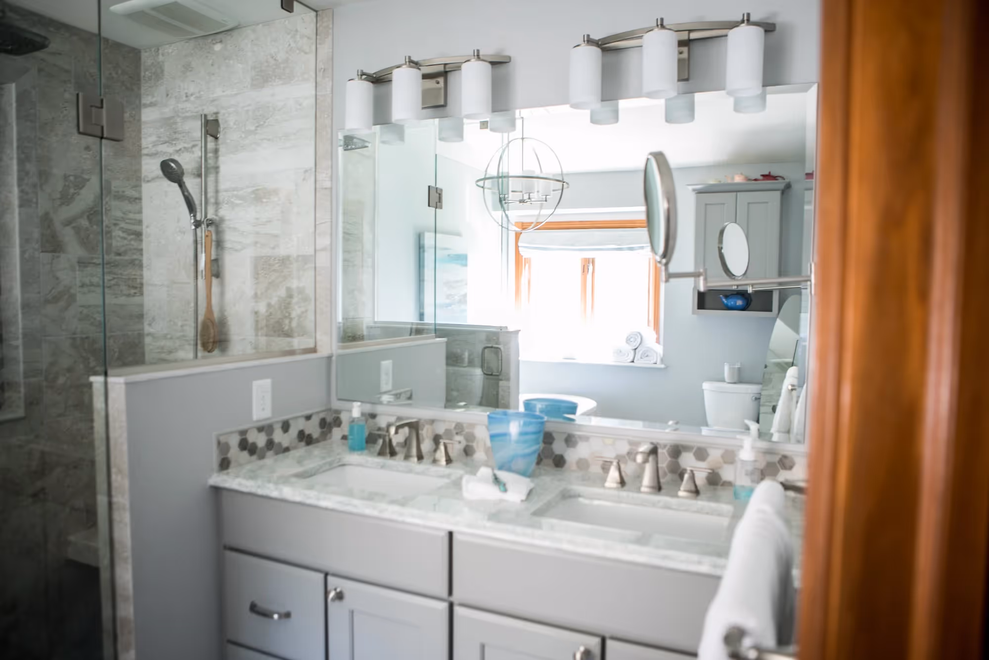 Bright bathroom with double sink vanity and large mirror.
