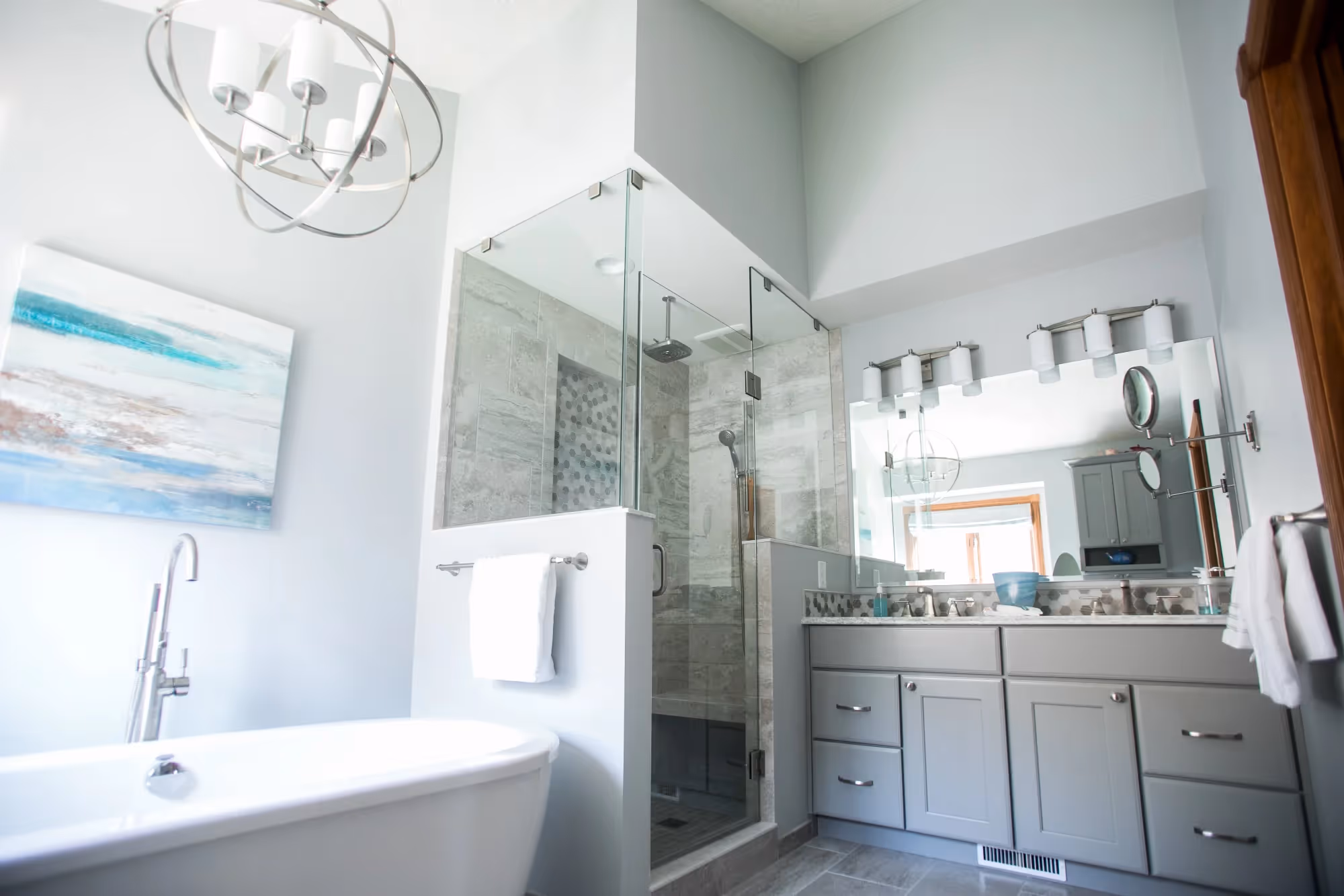 Bright bathroom with white vanity and large mirror