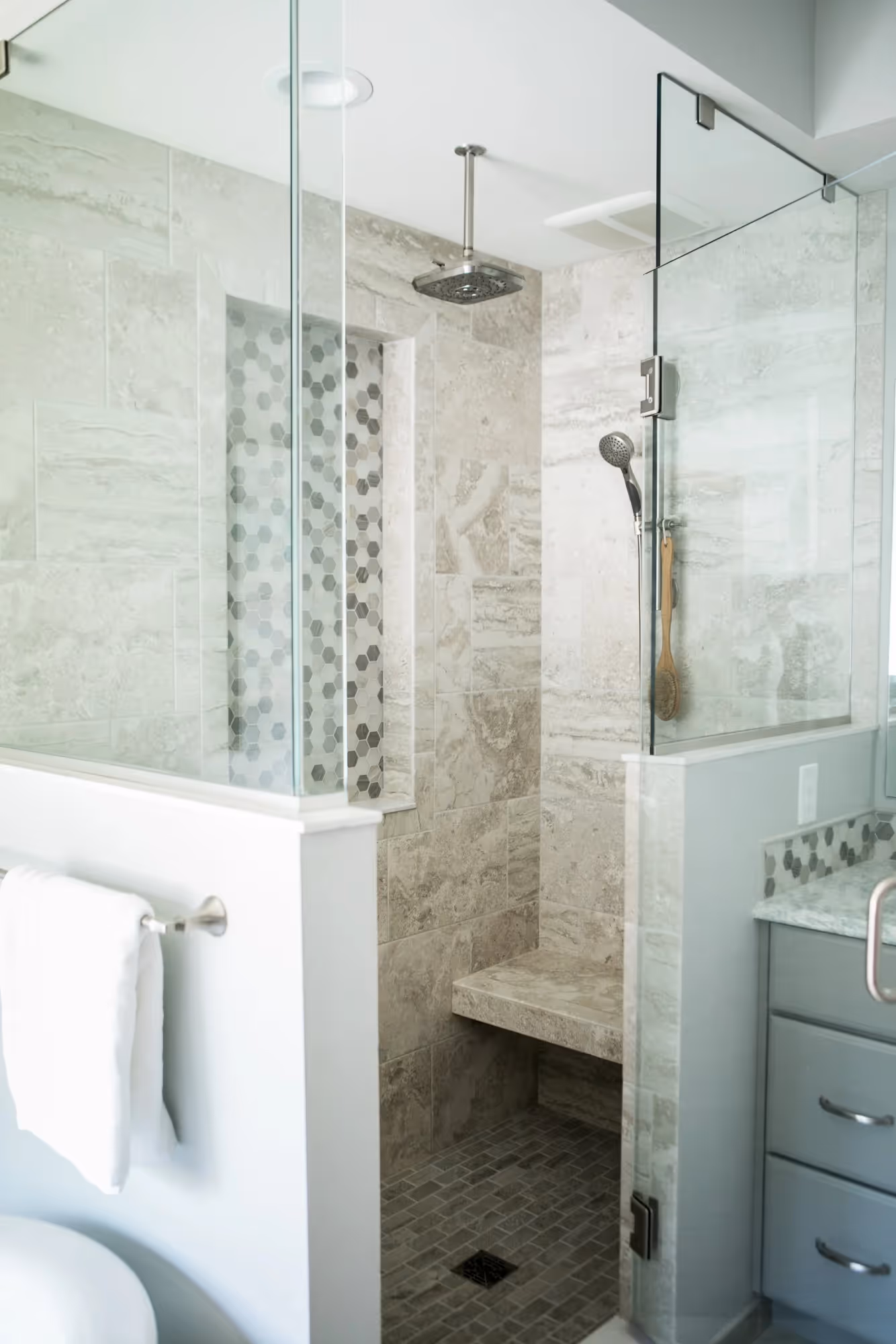 Contemporary bathroom design with a walk-in shower and vanity sink.