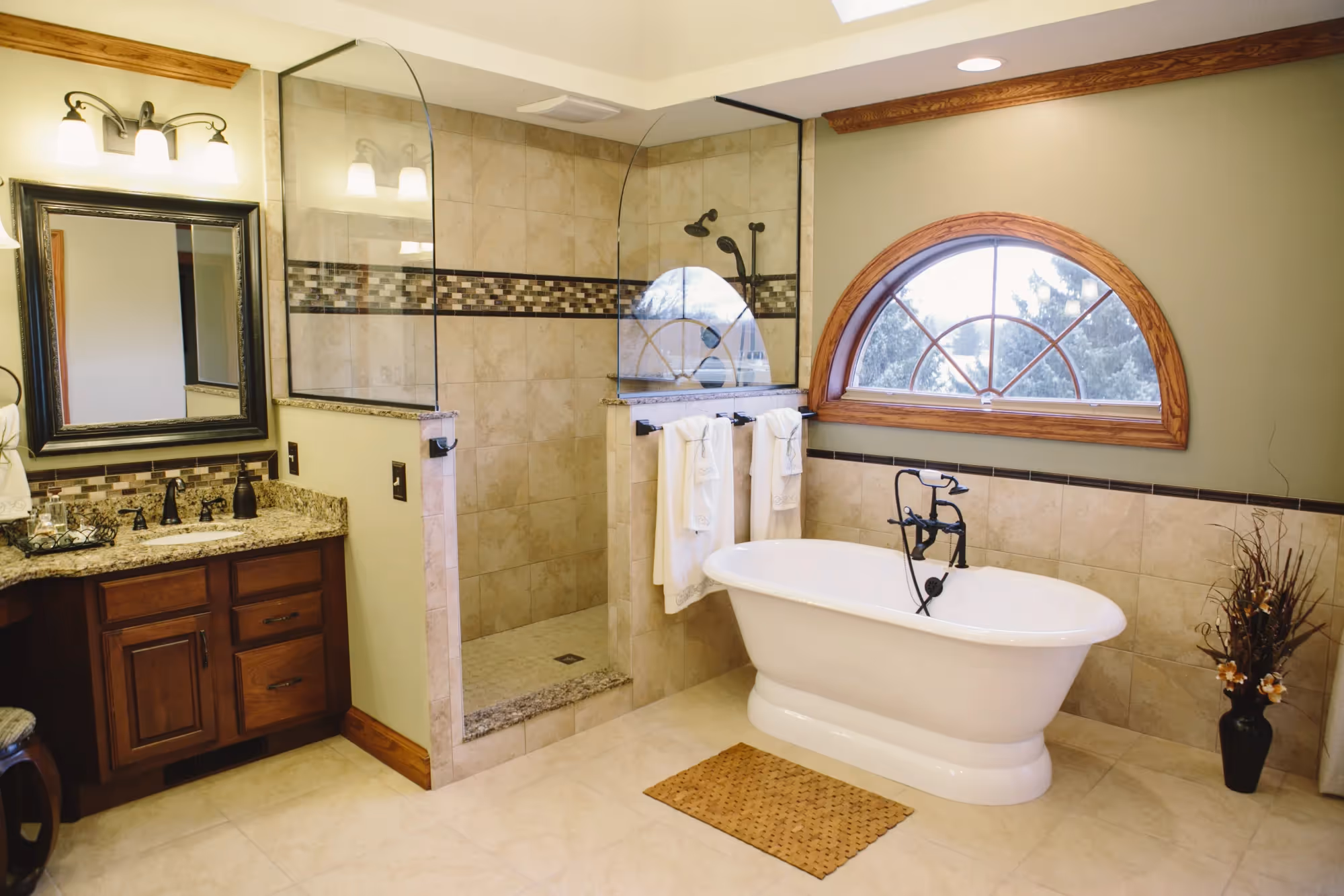 Primary bathroom with double vanity, tub, and walk-in shower