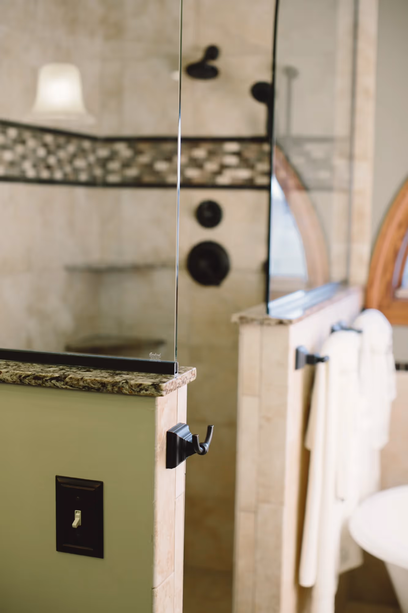 Tiled shower with glass door and small window