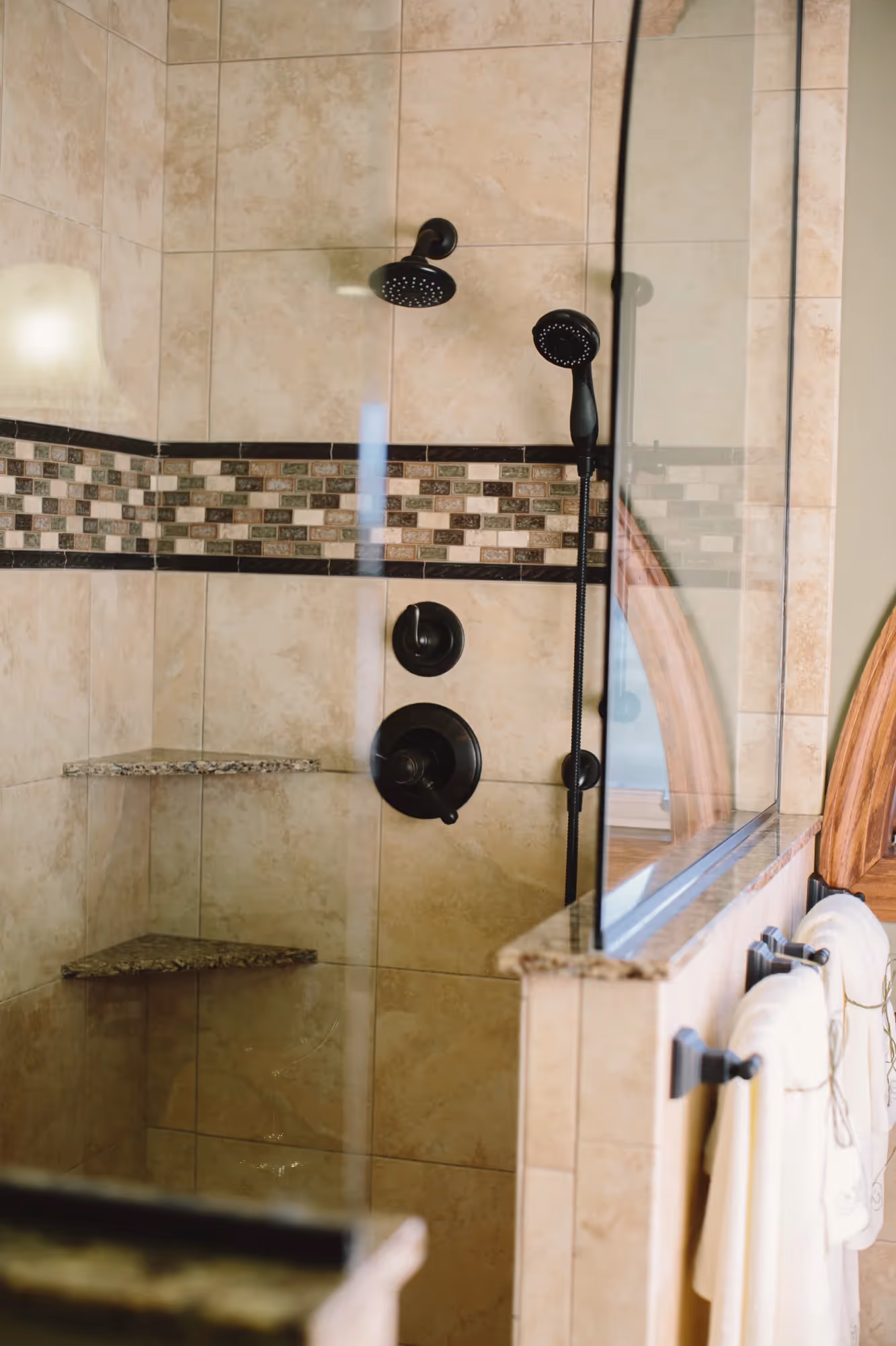 Walk-in shower with glass door and shower fixtures