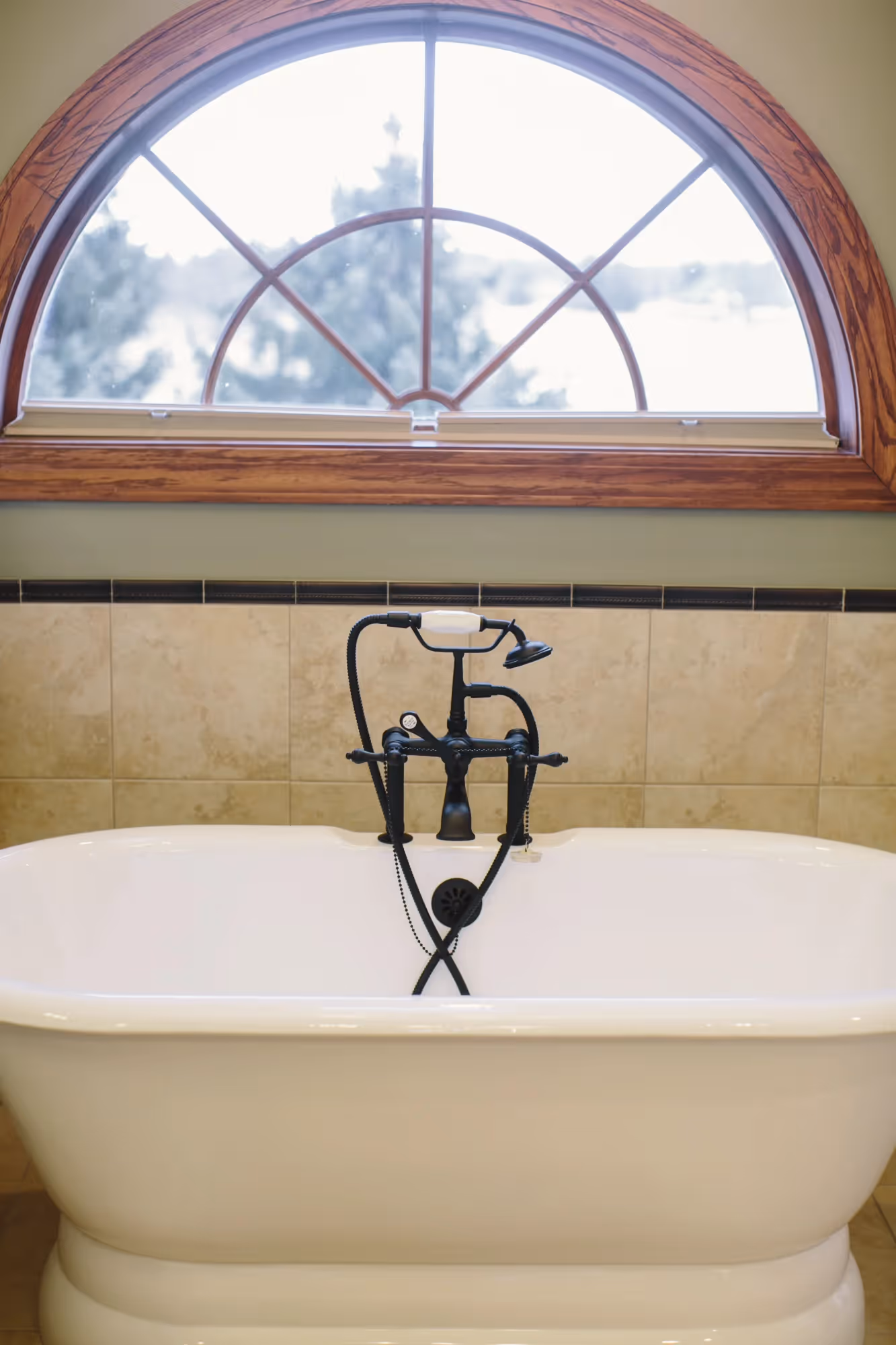 Arched window with wall sconce light fixture