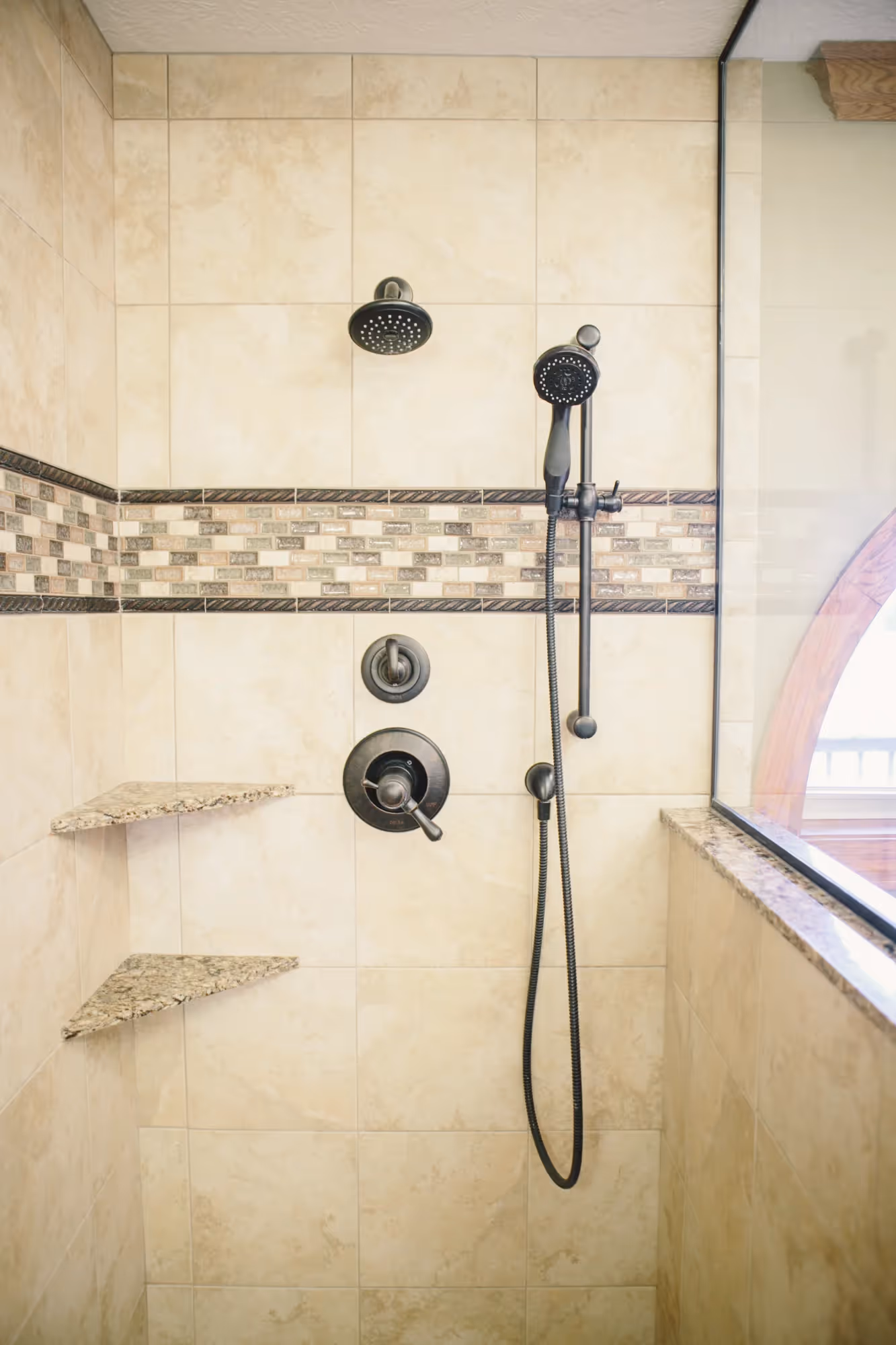 Walk-in shower with wall-mounted showerhead and controls