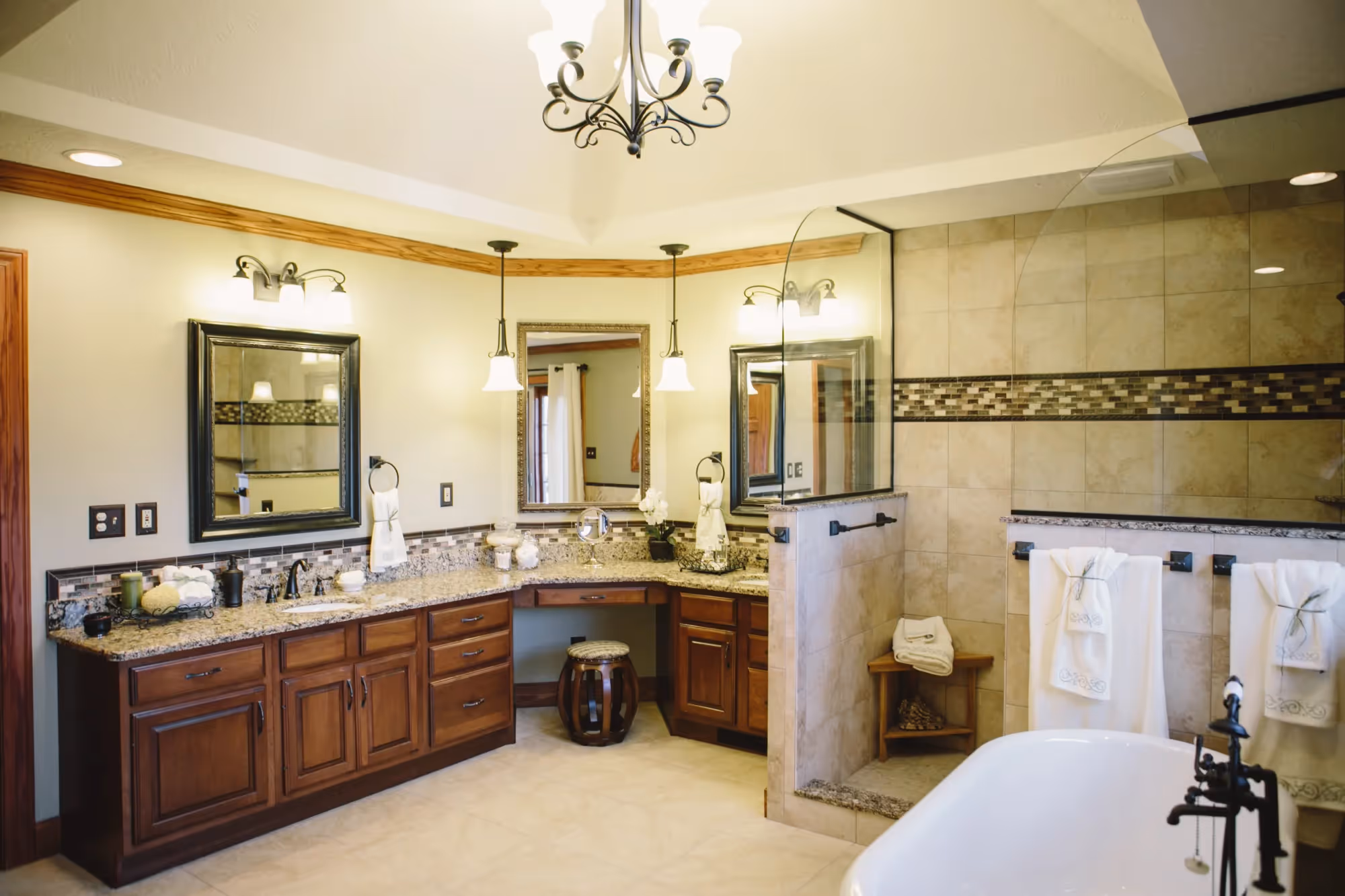 Wide view of bathroom with double vanity and walk-in shower