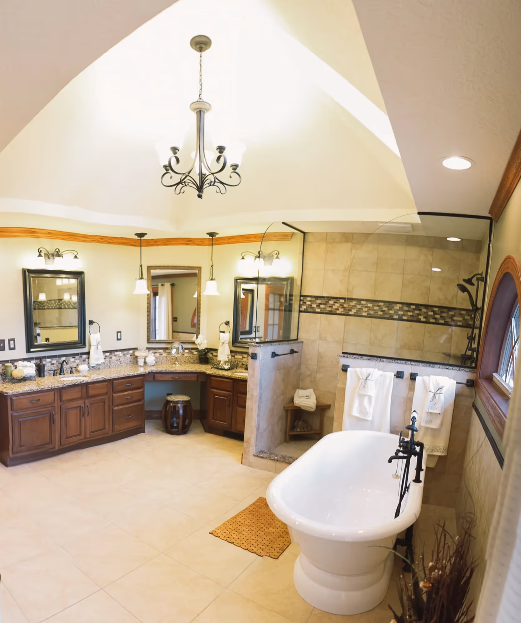Bathroom with freestanding tub and chandelier