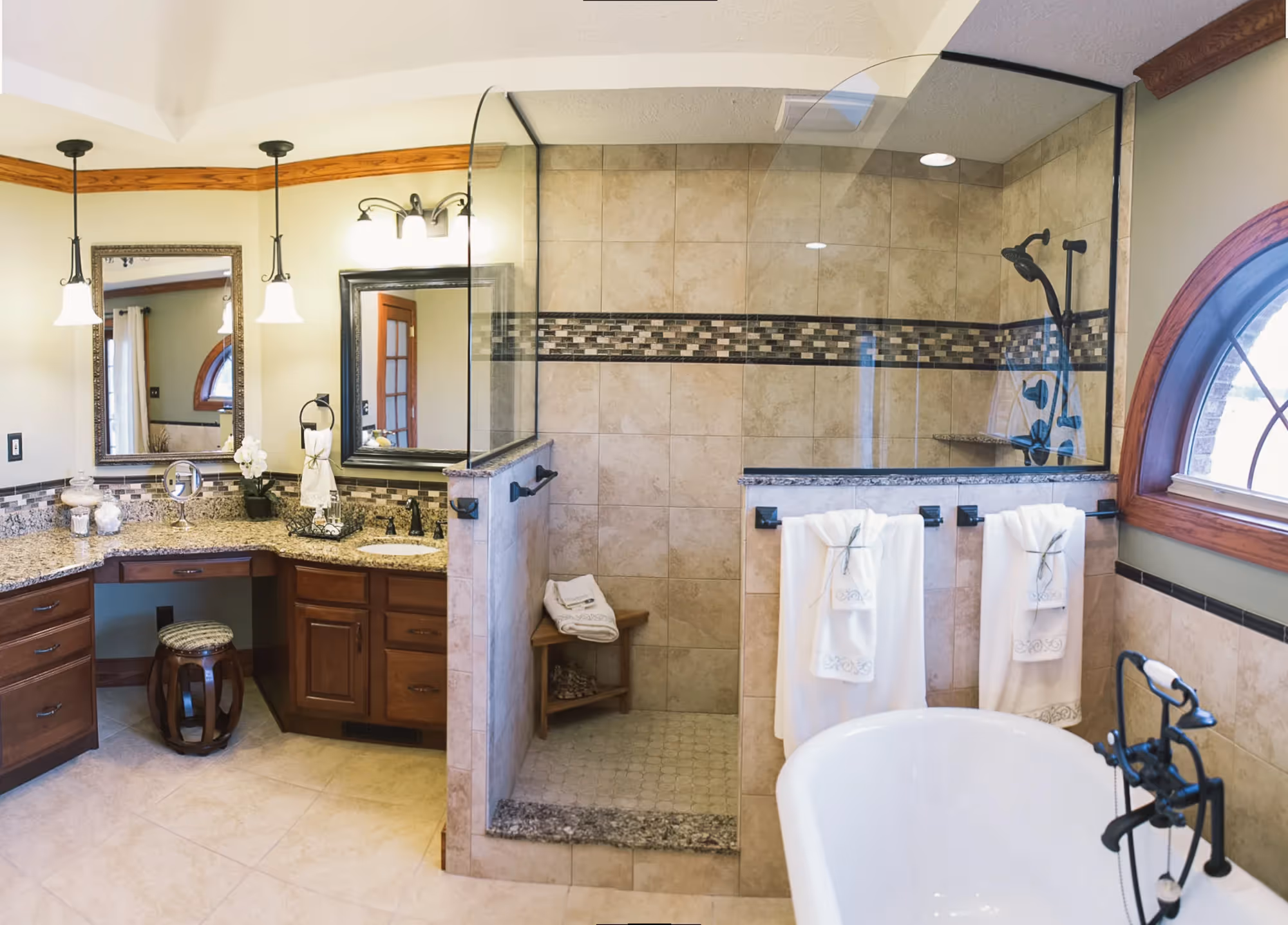 Bathroom with double vanity, tub, and glass-enclosed shower