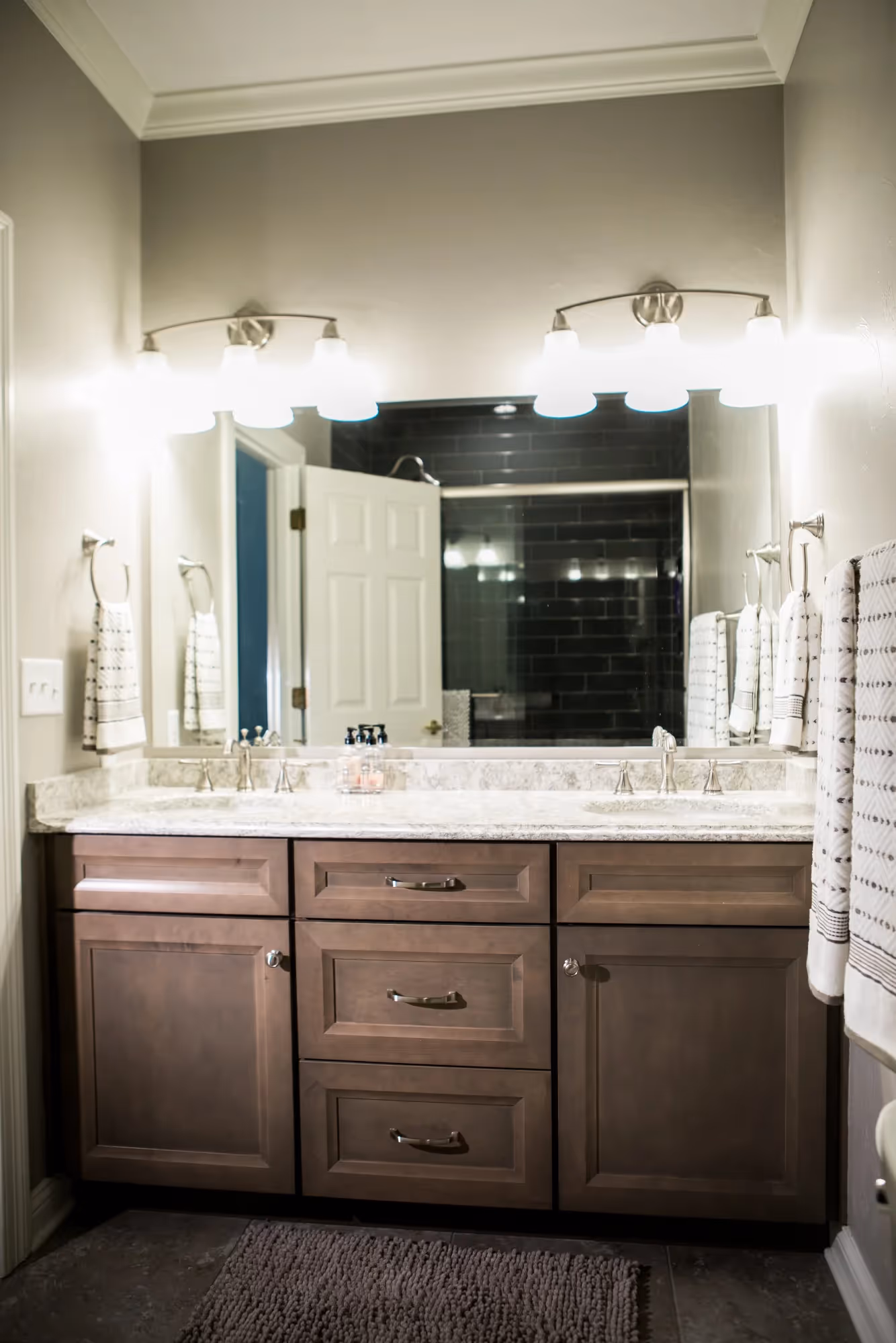 Wide bathroom view with double sink vanity and large mirror.