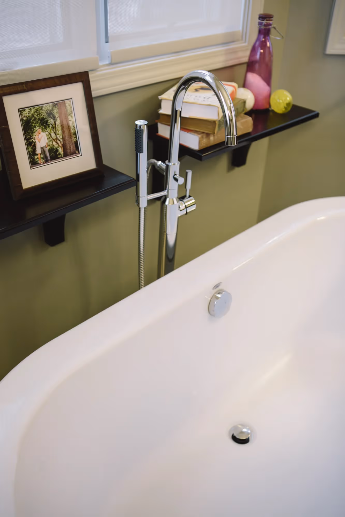 Bathroom with a bathtub and framed wall art.