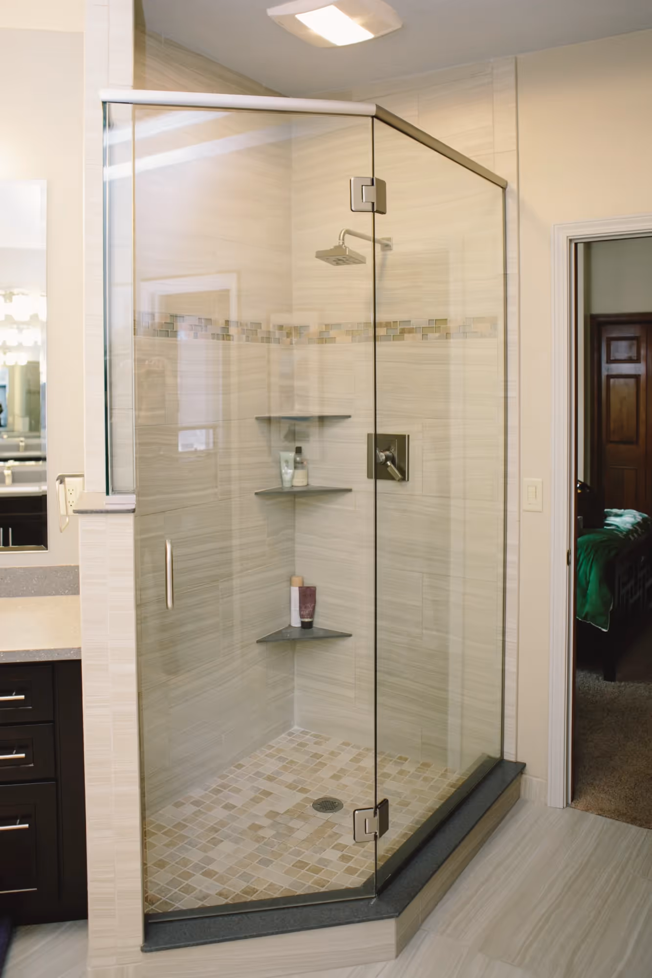 Modern bathroom with glass shower enclosure and tiled walls