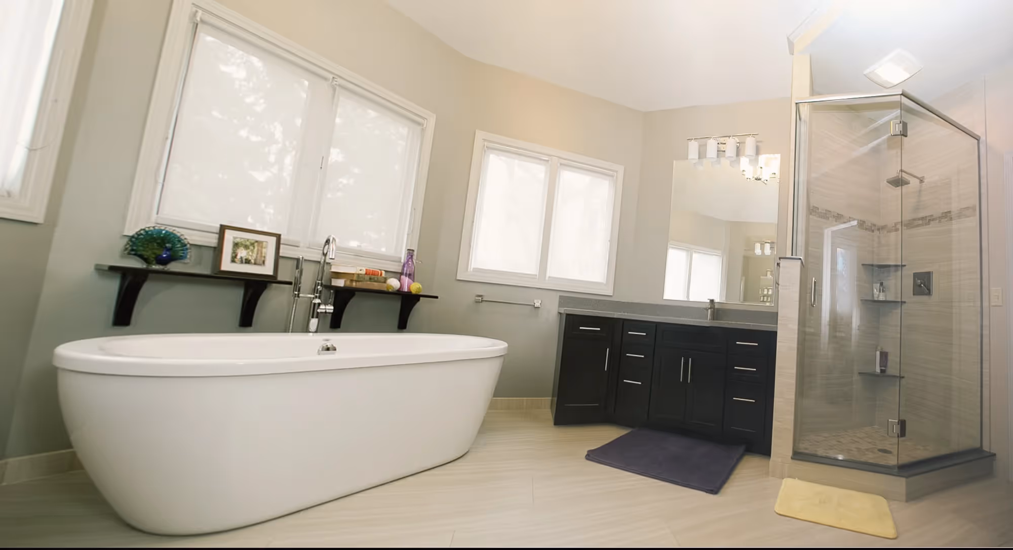 Spacious bathroom with bathtub and glass shower enclosure.