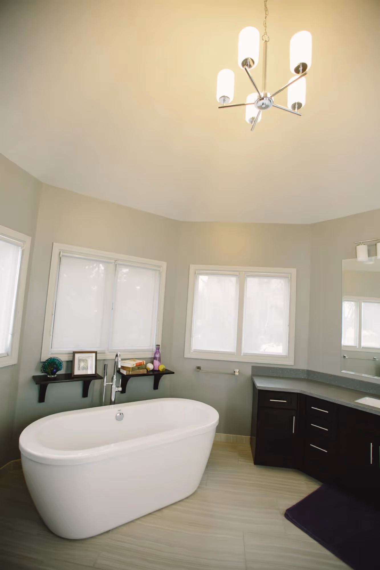 Bathroom with sink, mirror, and overhead lighting.
