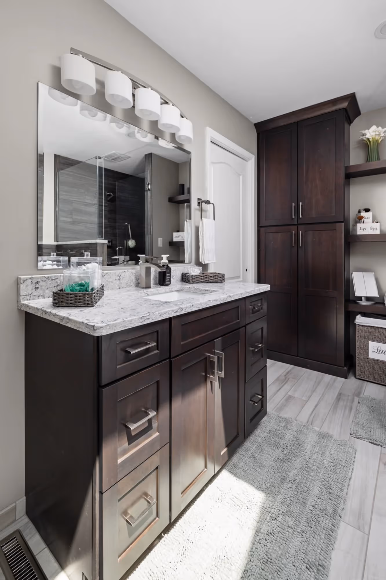 Bathroom vanity with dark wood cabinets