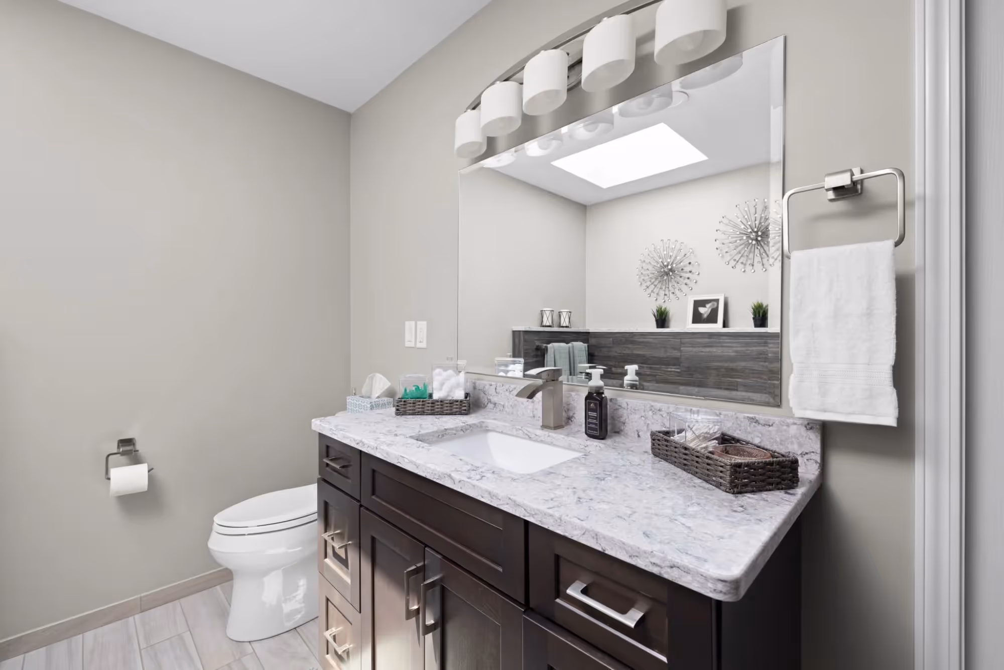 Bathroom vanity with illuminated mirror and sink