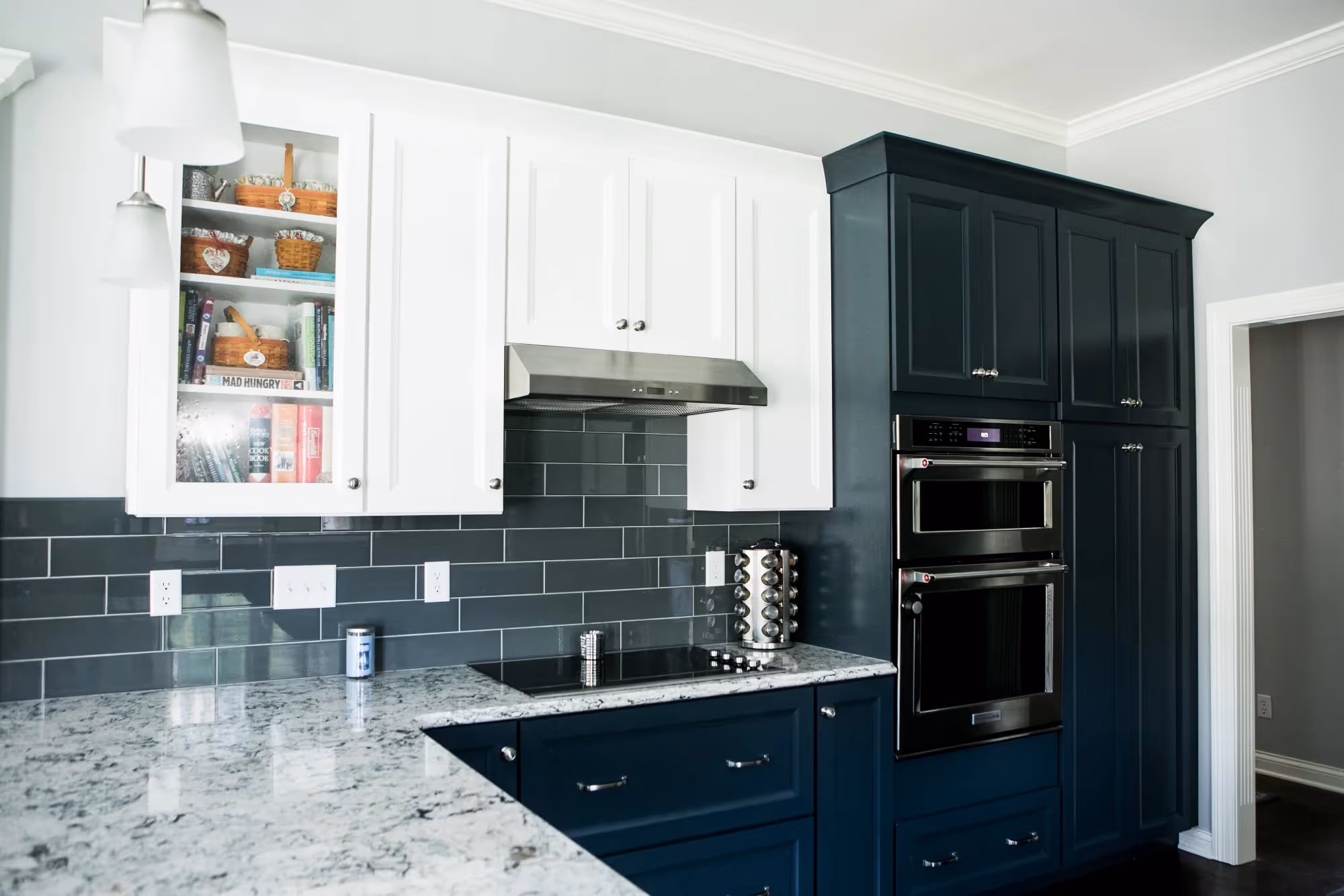 Contemporary kitchen with dark backsplash and built-in appliances