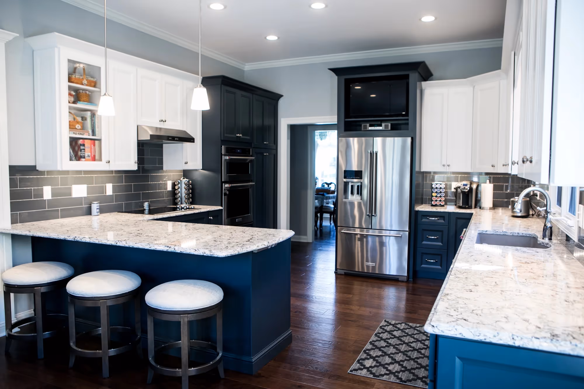 Open-concept kitchen and dining area with blue island and seating