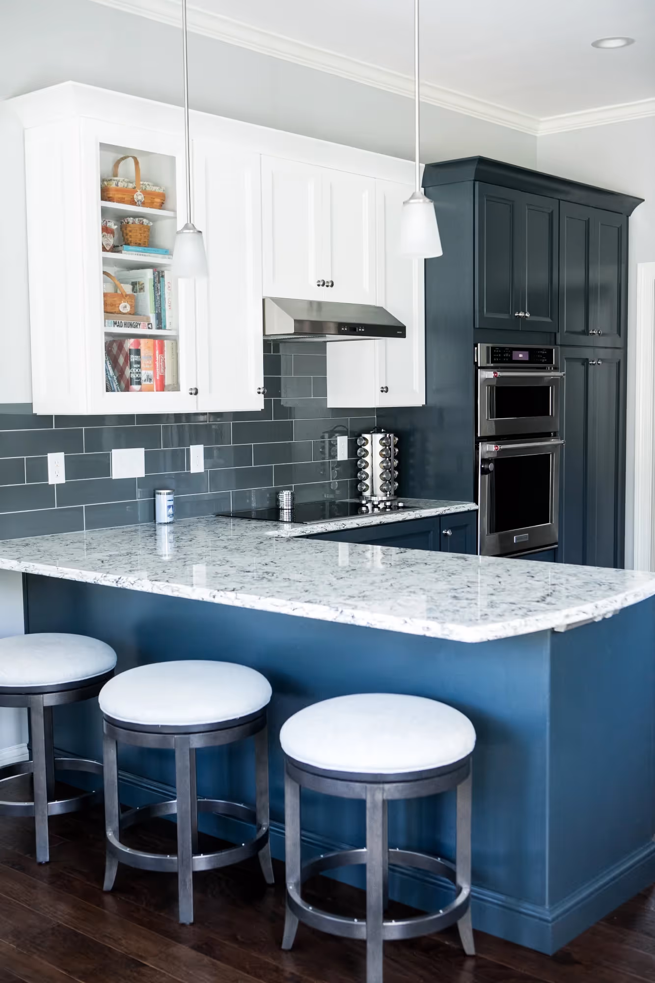 Modern kitchen with blue cabinets and bar stools