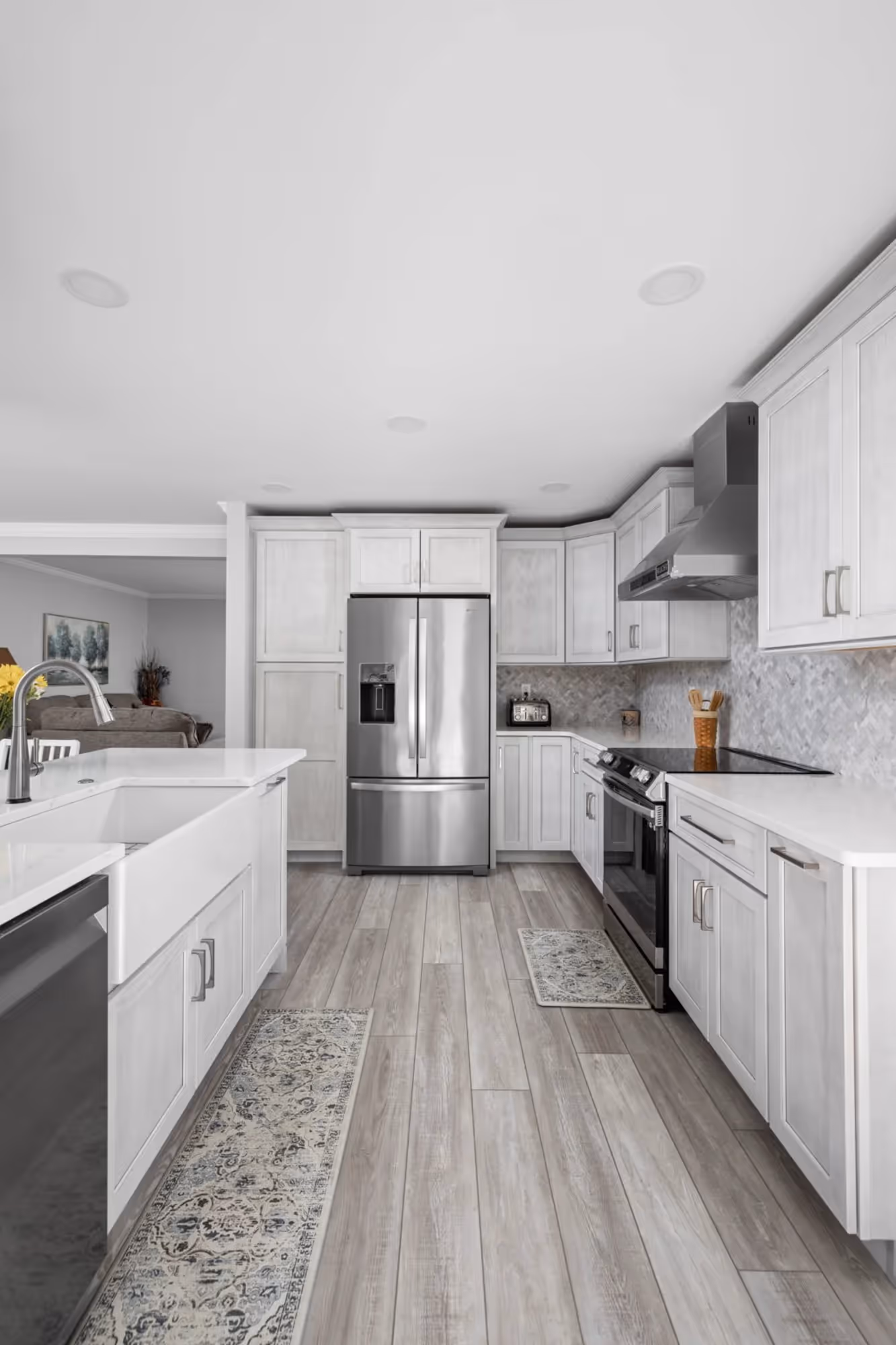 Modern kitchen with white walls, counter top and cabinets.