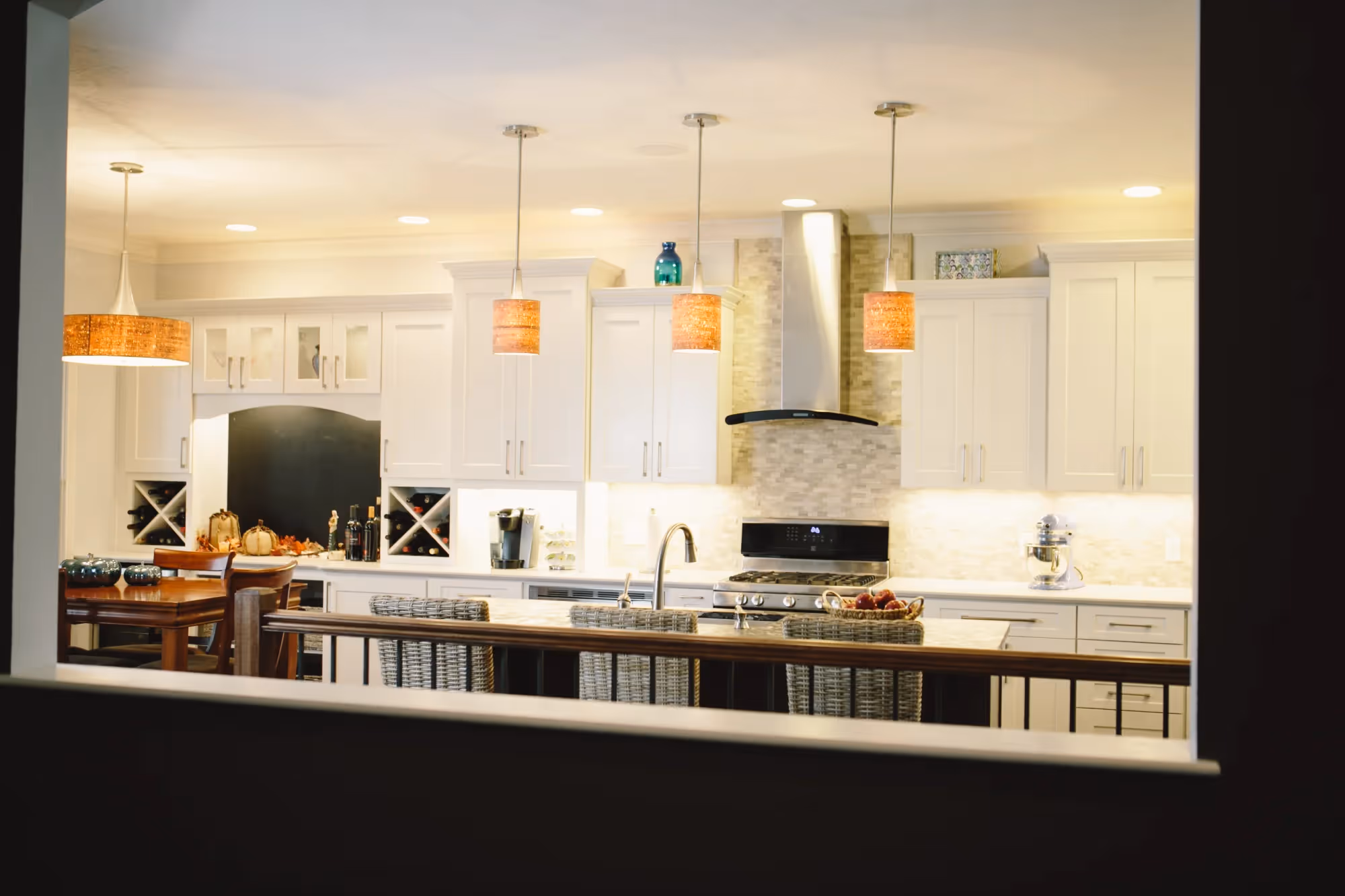 Bright kitchen with pendant lights over an island.