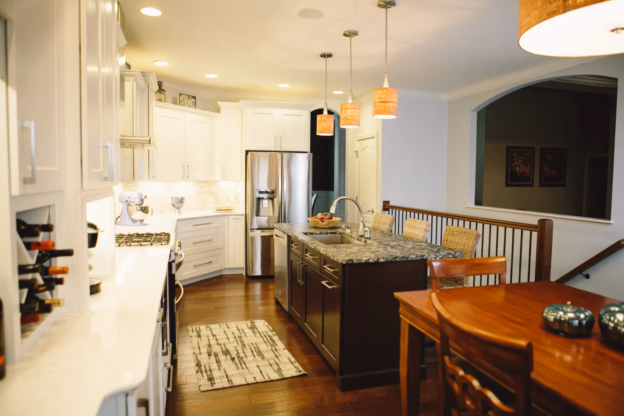 Warm-toned kitchen and dining area with pendant lighting.
