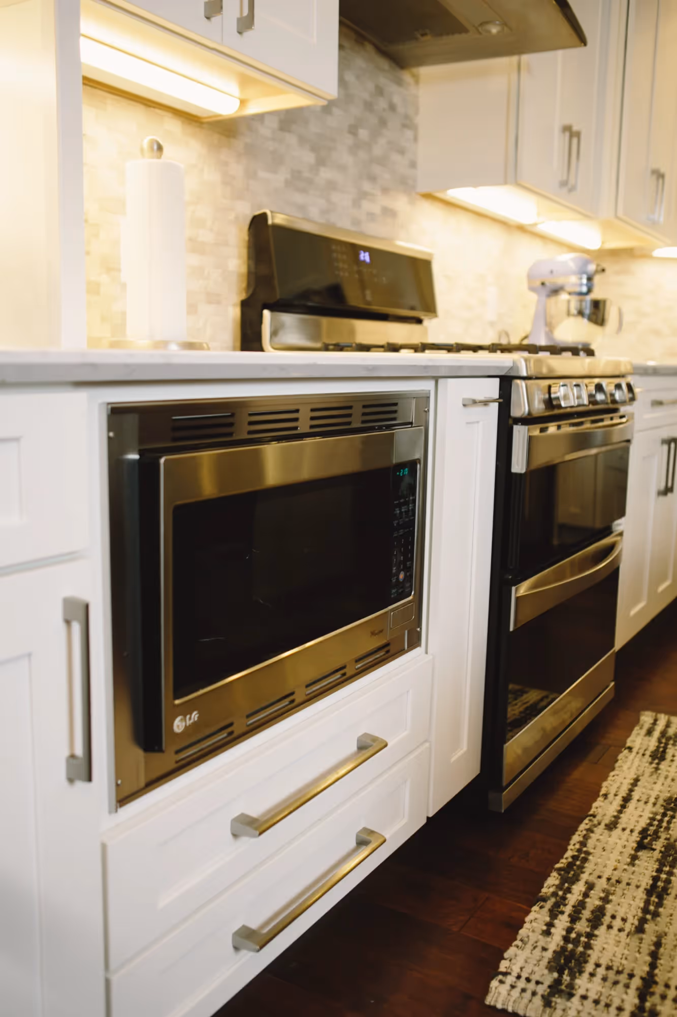 Built-in microwave above a white oven.