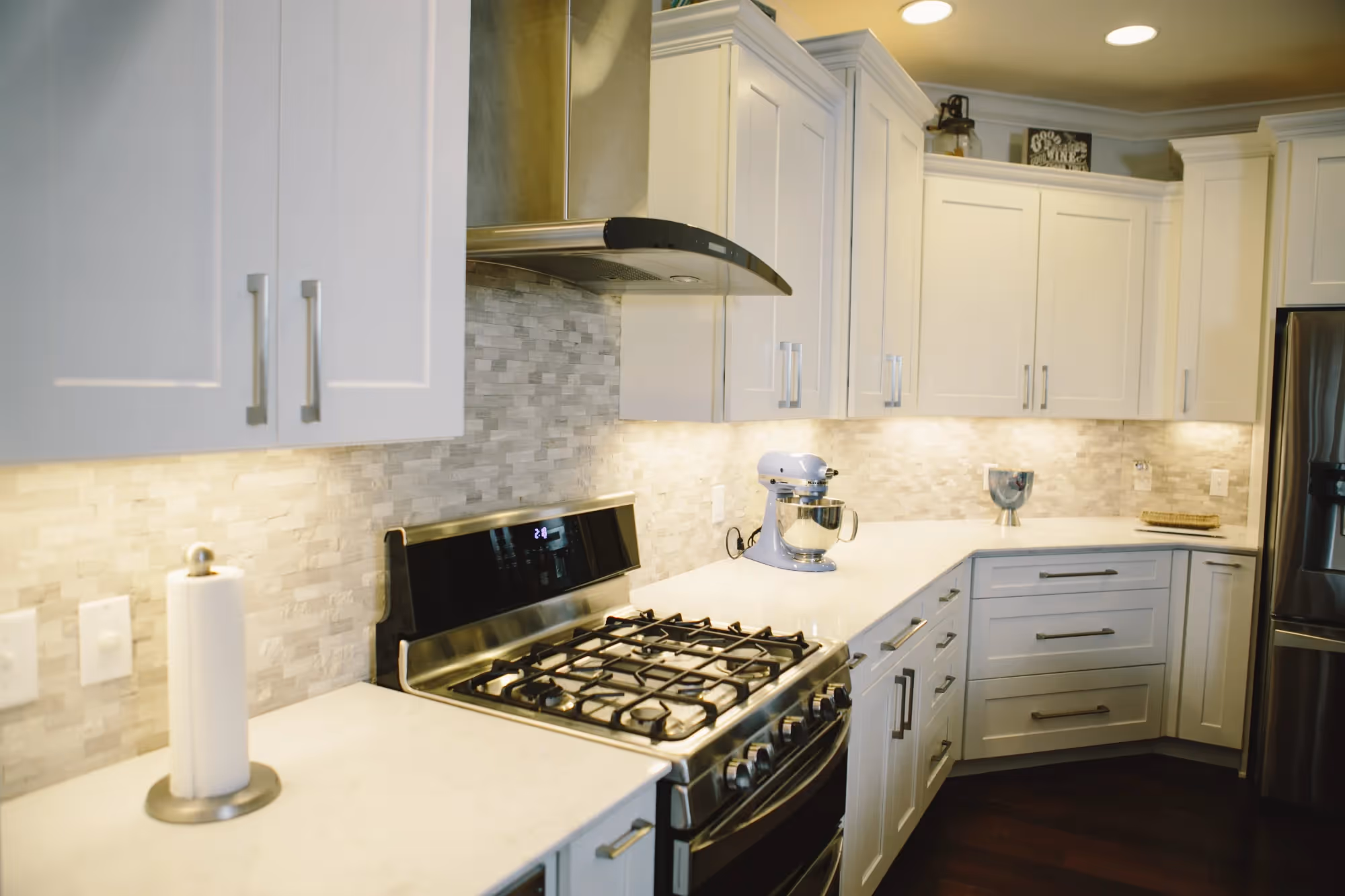 Bright kitchen with white cabinets and Chimney