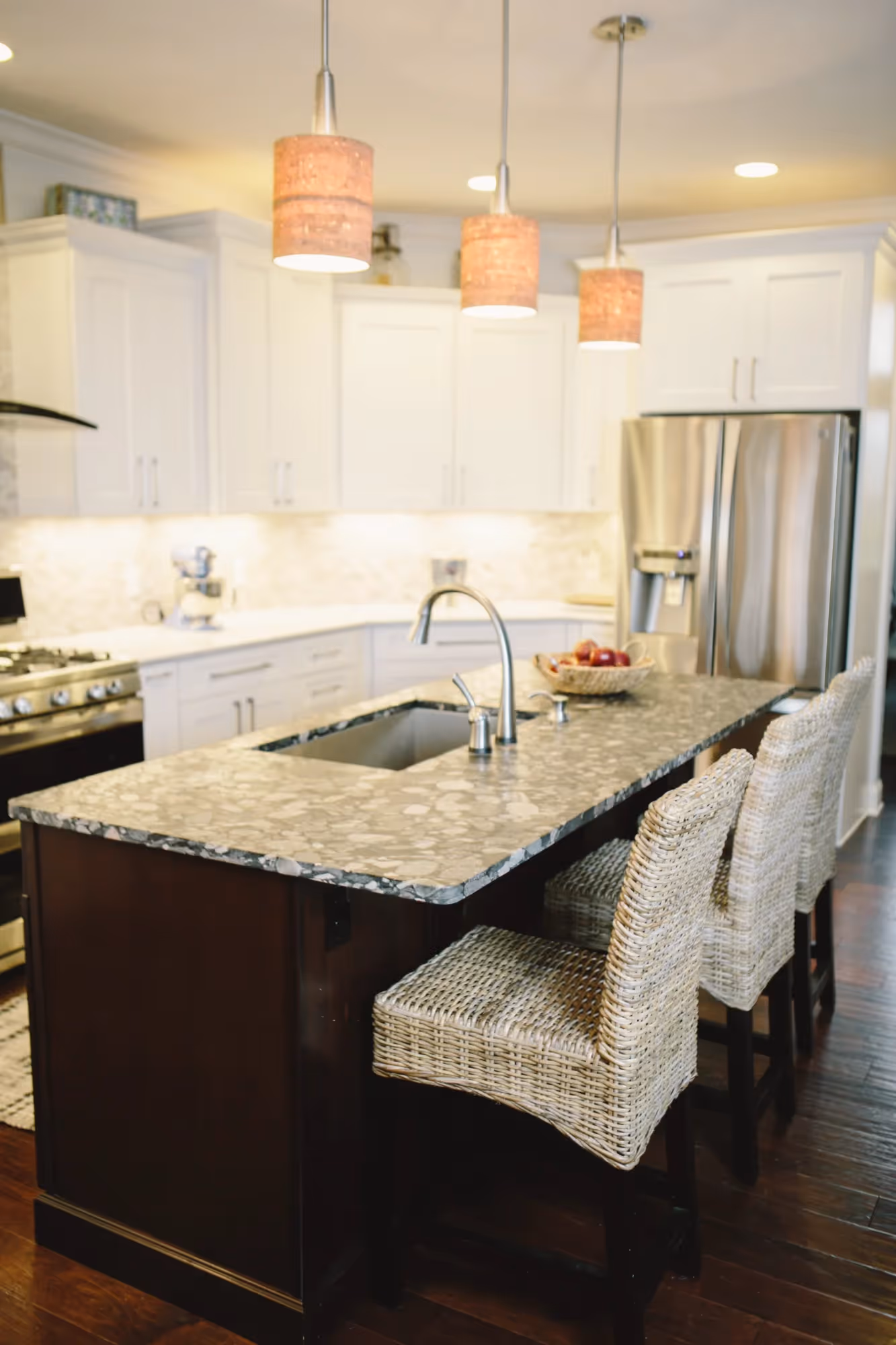 Granite island with sink and pendant lights